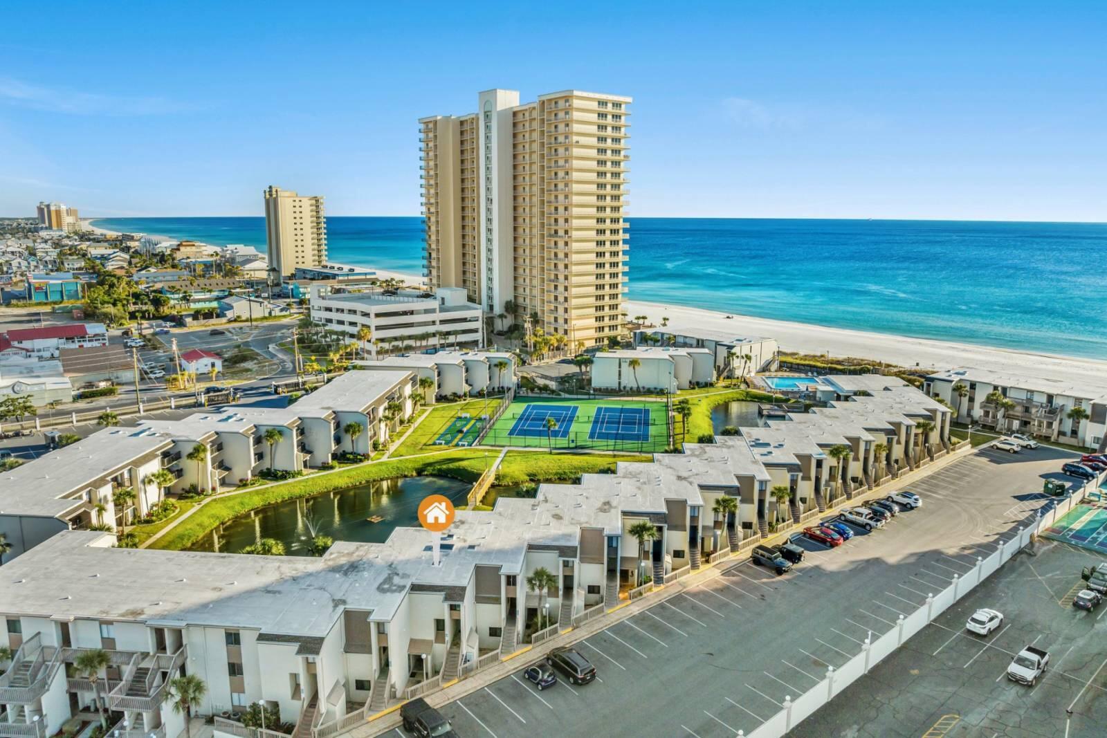Welcome Home! This spacious and stunning custom-designed beach condo is located in the privately gated & gulf front beach community of Sugar Beach! It will truly leave you speechless. Enjoy endless gulf and lake views from multiple private balconies - Waterfront living at its best. The oversized kitchen showcases endless granite countertops, beautiful storybook cabinetry, stainless steel appliances, a gorgeous hand selected backsplash + so much more! The spacious master bedroom features a custom built ensuite featuring a steamy glass shower + multiple closets. NO CARPET! Gorgeous flooring throughout. Enjoy private gated beach access, pool, tennis, shuffleboard, grilling area, huge koi/turtle pond, countless nearby restaurants/activities, + All of PCB to enjoy!