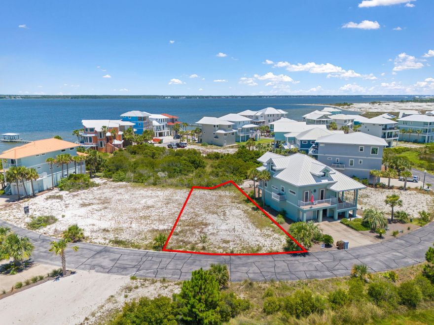 Imagine owning a prime lot at Navarre Beach with stunning water views overlooking a conservation area on the tranquil Santa Rosa Sound. Picture yourself waking up to the serene Sound views from your backyard and potentially catching breathtaking Gulf views from your front balcony. This lot is not just land; it's the canvas for your dream home or perfect vacation retreat, nestled in the peaceful, gated neighborhood of Caribbean Isles. Caribbean Isles isn't just a community; it's a lifestyle enhanced by street lights, underground utilities, and desirable amenities like a community pool, tennis courts, and a relaxing hot tub. Surrounded by 30 acres of pristine county-owned beach land to the W. and the majestic Santa Rosa Sound to the N. Bring your vision to life on this blank canvas.