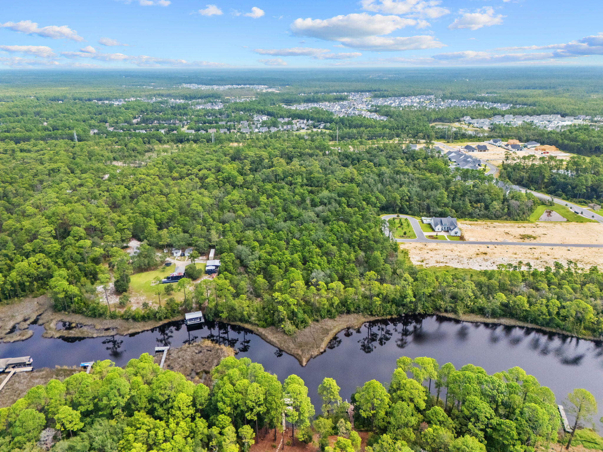 Another waterfront development opportunity in growing Inlet Beach. Over 5 acres of land now available, situated between the new homes being built in Watersound Origins Powell Landing and Watersound Origins Winter Garden. This particular tract has 32 feet of direct waterfront access to Lake Powell. While this parcel is currently zoned ''Conservation Residential'' by Walton County, which allows 2 homes per acres, you could assemble more land here, do Due Diligence on a Planned Community development order and make your own private waterfront community. Parcels have access to utilities, but they are not on the land at this time and buyer will have to pay for infrastructure to make utilities available.