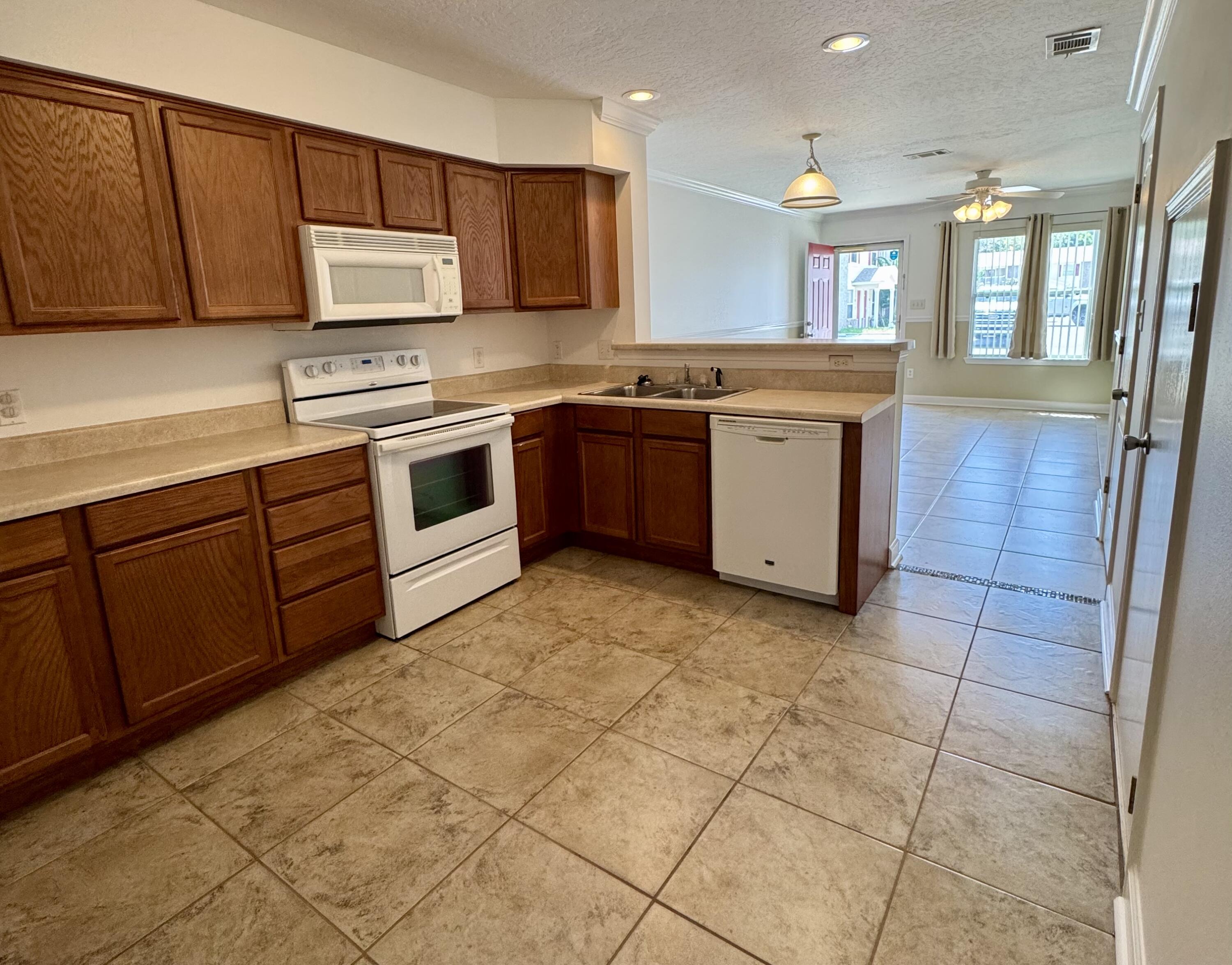 Awesome MOVE IN READY townhome in the beautiful Niceville area! Community pool will keep you cool in the summer. Built in 2006, the main floor has an open concept floor plan with a large living area, refrigerator, dishwasher, microwave and washer dryer all included. Large kitchen with plenty of counter space, efficient indoor laundry room by the kitchen and a half bath for your guests. Fresh paint throughout including all trim, doors and closets. Tile and carpeting just professionally cleaned. There are 2 bedrooms and a full bath upstairs. Both closets in the bedrooms are sizable! Super clean and ready for a new tenant to move in. Rear patio with a privacy fence. 15 Min from Destin Beaches, 15 Min from Eglin AFB.