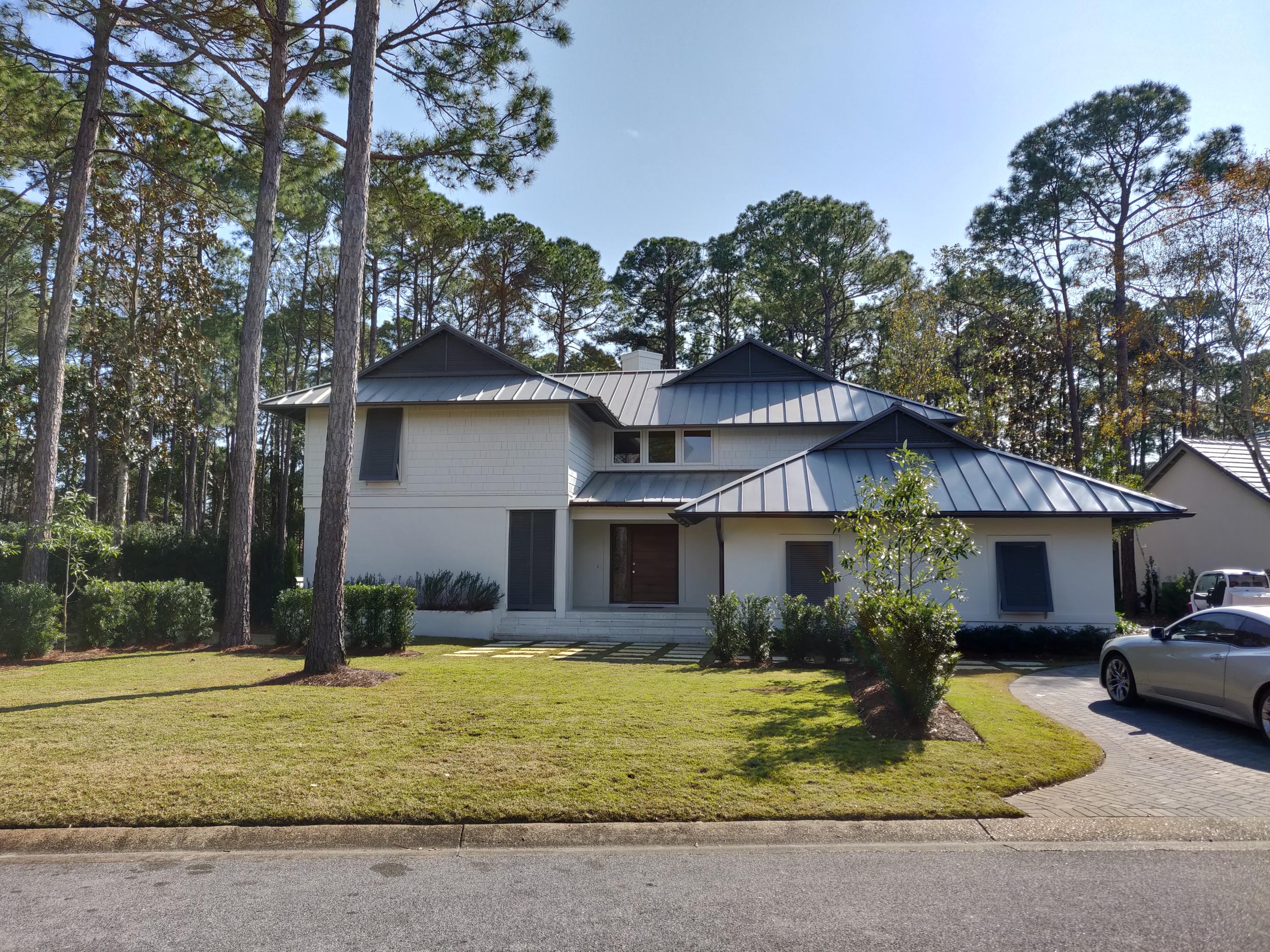 Unique Modern Designed Burnt Pine home tucked away in the pines with lots of Privacy. This 4 Bedroom home has 3.5 Baths and a Fireplace. The 2,671 sq. ft. Home has been Completely Renovated and shows like a Dream Model Home. Features of the Home are a Custom Hickory Front Door with sleek polished nickel hardware, Metal Roof, Copper Gutters, Stainless Appliances, White Peacock Paver Floors thru out the Living Area and White Walls and Carrera Marble Honed Countertops make this home a One of a Kind Home!Private Master Suite with Vaulted Ceiling and Modern Bath with a Walk In Custom Closet and Washer/Dryer.This house is COOL!Great Screened Porch with tall Ceilings overlooking the Custom Salt Water Pool and Spa with a Waterfall with a Completely Private backyard.