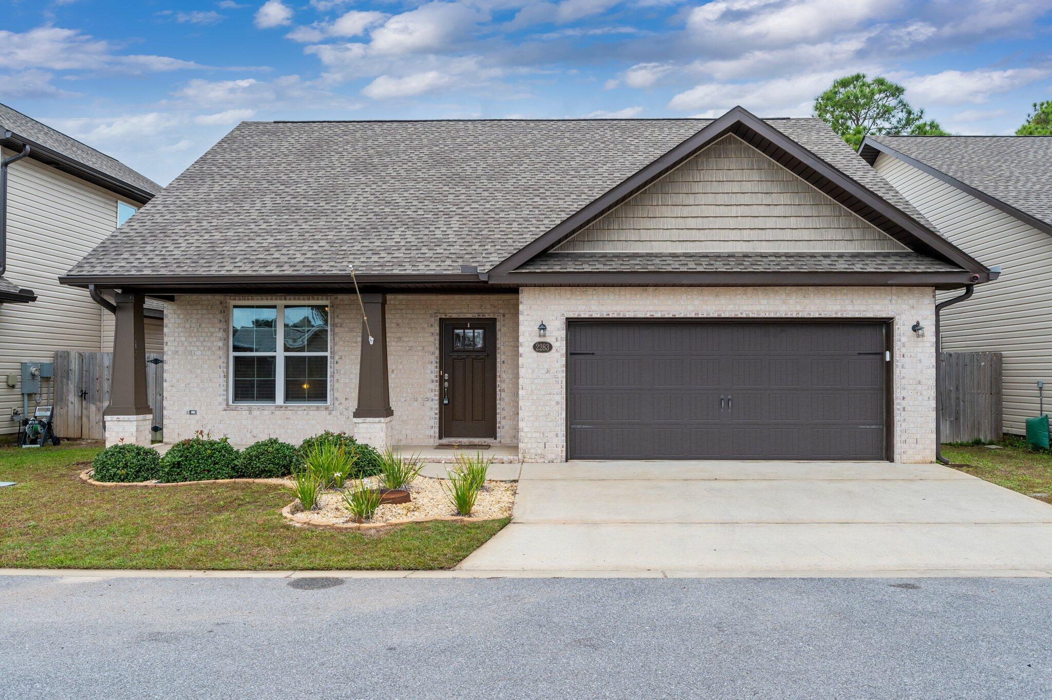 Welcome to 2283 Hadleigh Hills Ct.,This stunning like new construction built in 2021 has been thoughtfully designed. Featuring 3 spacious bedrooms with the primary bedroom on the first level. The interior is carpet-free, providing low-maintenance flooring that's both beautiful and practical. The open-concept layout flows effortlessly, offering a bright and welcoming atmosphere.Located just minutes from Navarre Beach, Hurlburt Field, shopping, and restaurants, this home is ideal for those who value convenience and coastal living. The modern kitchen, ample storage, and private backyard makes it a standout choice.