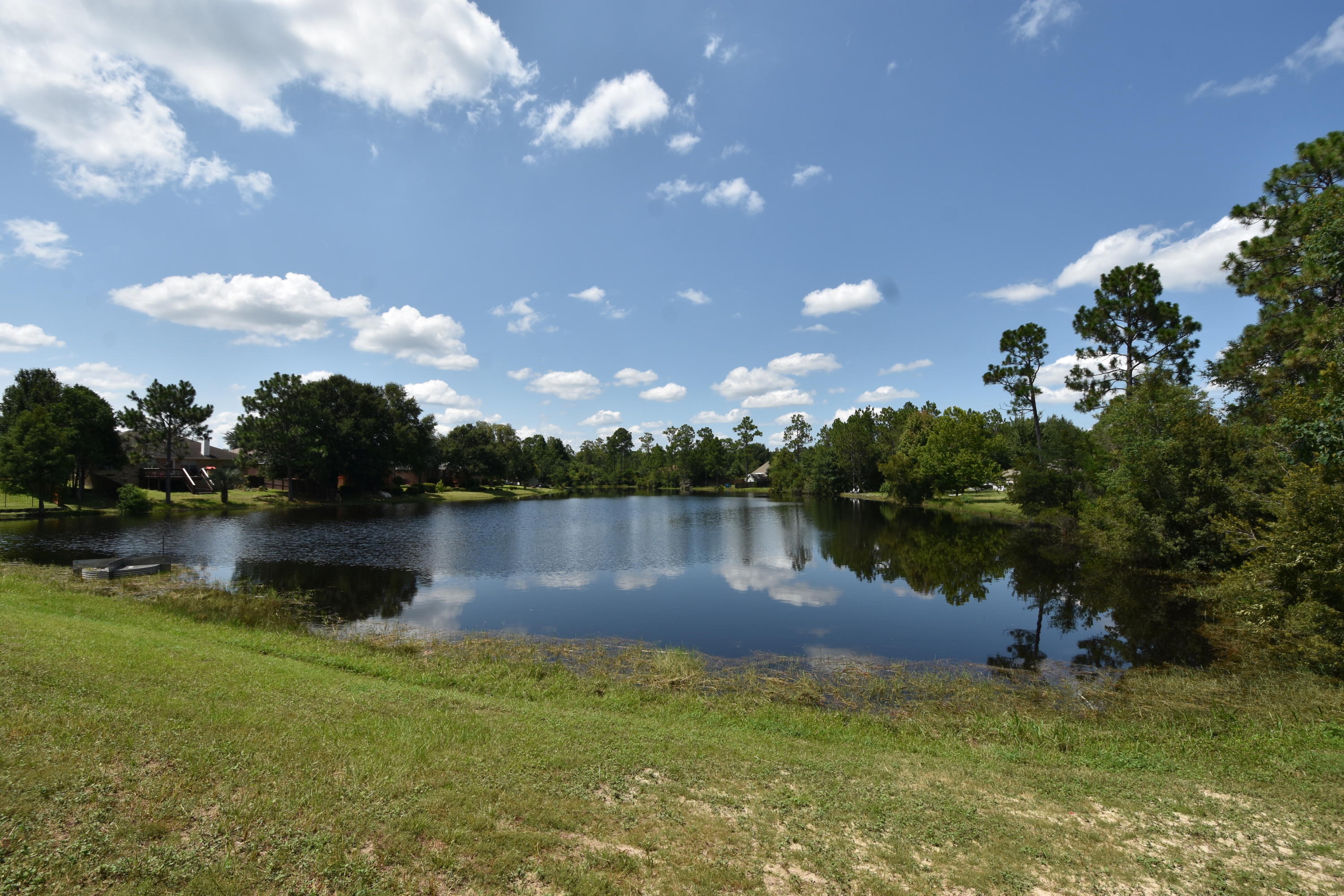 South of I-10 wooded building site in a neighborhood with lakefront lots having access to the lake. This lot is identified as a lakefront lot in the original Restrictive Covenants. Dimensions are taken from the tax plat. Minimum SF for one-story is 1400 SF. See Documents for original Restrictive Covenants. Electric, Phone, Cable, Water, Natural Gas are all available utilities. Sewer is not available. No utilities are onsite.