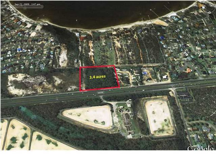 This is a very unique commercial lot on the south side of Highway 98 with views of the Sound and the Gulf of Mexico. Zoning allows a wide range of commercial use along the Highway frontage along with multifamily capabilities overlooking the Sound. Property's north, east, and southern boundaries have highway and paved road frontage, thus providing easy access and traffic circulation.