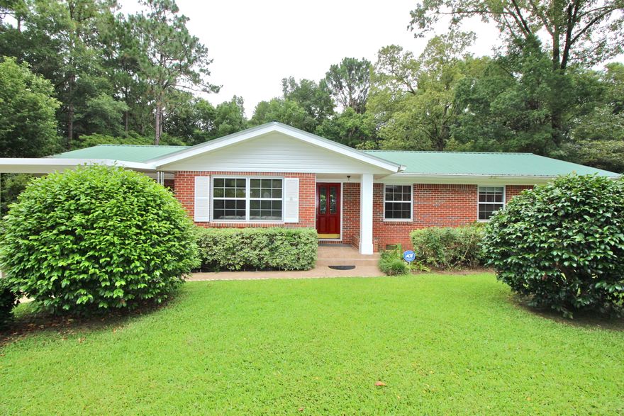 Back on market and price reduced! Classic DeFuniak home with one of the most spectacular yards in town - on a double lot! It is clear this family home was extremely well maintained in every possible way. Inside, you'll find original oak flooring, a large sunken den for family time - and a wonderful kitchen made for home cooking! There's also a safe step walk-in tub in the hall bath. Outdoors is a delight with both covered front porch & expansive back deck (partially open, partially covered). With the extra lot, total size is .69 acre! Lemon and pomegranate trees, hydrangeas, jasmine, magnolias, azaleas and roses fill the yard with a heavenly aroma and a stunning sight. Greenhouse and small workshop too. All located so conveniently, yet tucked away in a small, quaint neighborhood.