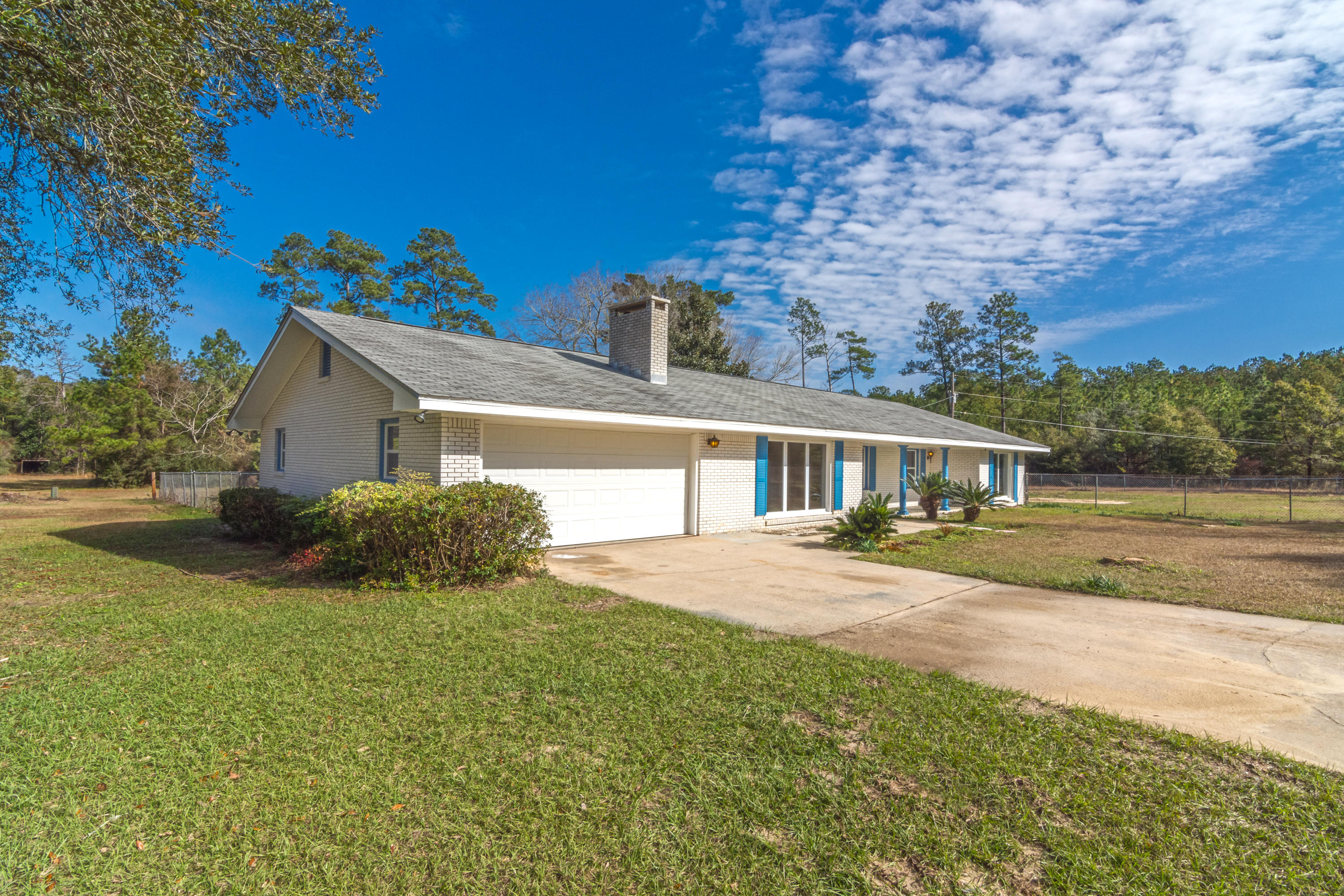 MOVE-IN READY ON 1.81 ACRES - this 4 bd/2 ba spacious home boasts many recent upgrades including new windows, fully renovated kitchen complete w/ granite countertops/stainless steel appliances, fresh paint & new flooring to name a few. The cozy living room features a beamed ceiling & wood burning fireplace. Nice dining area & adjoining kitchen w/ counter height bar. The 4 bedrooms & 2 bathrooms are all located to one side of the home & large bonus room w/ endless possibilities is on the opposite side of home. Spacious enclosed back porch, rear patio & fenced area for outdoor play! The home is situated on 1.81 acres which is being split out of a larger parcel. Buyer to verify all areas of importance including but not limited to zoning, lot/room sizes, school zones.