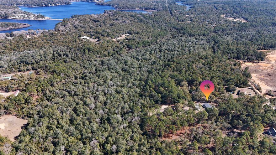 Total seclusion at the end of a private, gated, crushed concrete drive, where 5.84 ac. of Florida wilderness meets a meticulously maintained homestead designed for true self-sufficiency. This is more than a home; it's a private ecosystem featuring a KINGS LAKE FED CLEAR CREEK with fish & wildlife. It's a 'grocery store' in your backyard. The creek and orchard are a homesteader's dream. There's a massive variety of mature fruit and nut trees including Asian Plum, Guava, Fig, Peach, Cherry, Pear, Citrus, and more. Complemented by raised garden beds, a greenhouse, and a pro composting system plus extras. Features maintained ATV riding trails with jumps & mini golf. $10k Culligan water filtration system included. Bonus structure with power. Manufactured Home Permanently Attached.  Flood Zone X Welcome to 507 Stewart Drive
The Ultimate Private Creek-Front Estate
Introduction: A Rare Opportunity in DeFuniak Springs
Are you searching for the perfect balance of modern comfort and rugged outdoor freedom? Welcome to 507 Stewart Drive, a stunning 5-bedroom, 3-bathroom residence nestled on 5.84 pristine acres in the highly coveted Kings Lake area. Built in 2021, this spacious manufactured home still boasts that "new home" feel, offering plenty of room to spread out without a neighbor in sight. Whether you are an avid gardener, a hunting enthusiast, or an ATV rider, this property is designed for those who value privacy and the great outdoors.

The Entrance: Seclusion Meets Curb Appeal
From the moment you arrive, you'll notice the natural green buffer and secure double-gated fence line providing total peace of mind. The approach is as functional as it is beautiful; the owners invested $8,000 in a premium crushed concrete driveway, ensuring your vehicles stay clean while maintaining the rustic elegance of a country estate.

Hobbyist's Paradise: Workshop, Greenhouse, & Entertainment
This property is a dream for the "do-it-yourself" enthusiast. Highlights include:
" Powered Workshop/Studio: A versatile space ready for your hobbies, or easily convertible into additional living quarters.
" Gardener's Dream: Includes a dedicated greenhouse, raised garden beds, and hundreds of dollars in high-quality planters to       jumpstart your botanical oasis.
" Outdoor Living: Relax on the expansive multi-level back deck overlooking a custom-landscaped mini-golf green.
" Family Fun: Custom oversized steppingstones lead the way to a large children's playhouse (which can stay or be removed at the buyer's request).

Adventure at Your Doorstep: ATV Trails & The Creek
For the thrill-seekers, the backyard features professionally landscaped ATV trails, complete with wide roads and two custom jumps.
The crown jewel of the estate, however, is the 1,261 feet of clear, lake-fed creek winding through the property. The owners have cleared two private trail access points leading down to the water's edge. There, you'll find a charming elevated tiny house--the ultimate off-grid retreat--perfect for creek-side camping or enjoying the solar-powered ambiance at night.
A Natural Wildlife Corridor
Located near the expansive Kings Lake, this property acts as a "natural highway" for Florida's local fauna. Because hunting hasn't been permitted on-site, the wildlife is incredibly peaceful. It is common to see deer grazing in the backyard even while you're outside. The owners have frequently spotted:
" Deer & Fox
" Bobcats (The Florida Lynx)
" Coyotes

Pure Luxury: The Water System
Forget the typical issues associated with rural living. This home features a deep well equipped with a $10,000 Culligan Water Filtration system. You will enjoy bottled-water quality from every tap, free of iron deposits or odors. From the taste of your morning coffee to the luxury of a soft-water shower, this system provides a level of pampering rarely found in a country setting.
________________________________________

507 Stewart Drive isn't just a house; it's a lifestyle. Come experience the seclusion, the wildlife, and the endless possibilities of this DeFuniak Springs gem.
