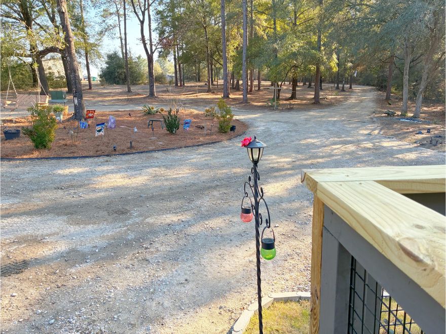 Total seclusion at the end of a private, gated, crushed concrete drive, where 5.84 ac. of Florida wilderness meets a meticulously maintained homestead designed for true self-sufficiency. This is more than a home; it's a private ecosystem featuring a KINGS LAKE FED CLEAR CREEK with fish & wildlife. It's a 'grocery store' in your backyard. The creek and orchard are a homesteader's dream. There's a massive variety of mature fruit and nut trees including Asian Plum, Guava, Fig, Peach, Cherry, Pear, Citrus, and more. Complemented by raised garden beds, a greenhouse, and a pro composting system plus extras. Features maintained ATV riding trails with jumps & mini golf. $10k Culligan water filtration system included. Bonus structure with power. Make it yours. Unique property. MH Perm Attach