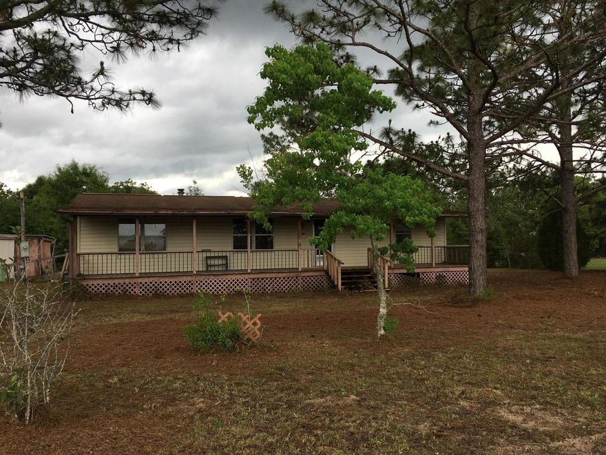 Beautiful 1.02 ac, awaits your dream home or fix up mobile home. This property has a double wide mobile home, being sold as is. It could be a potential fixer upper. Peace and quiet in a country setting yet close to Crestview, Fl with shopping, dining and entertainment. Property has an existing fence around it. Workshop in the back, as is also.