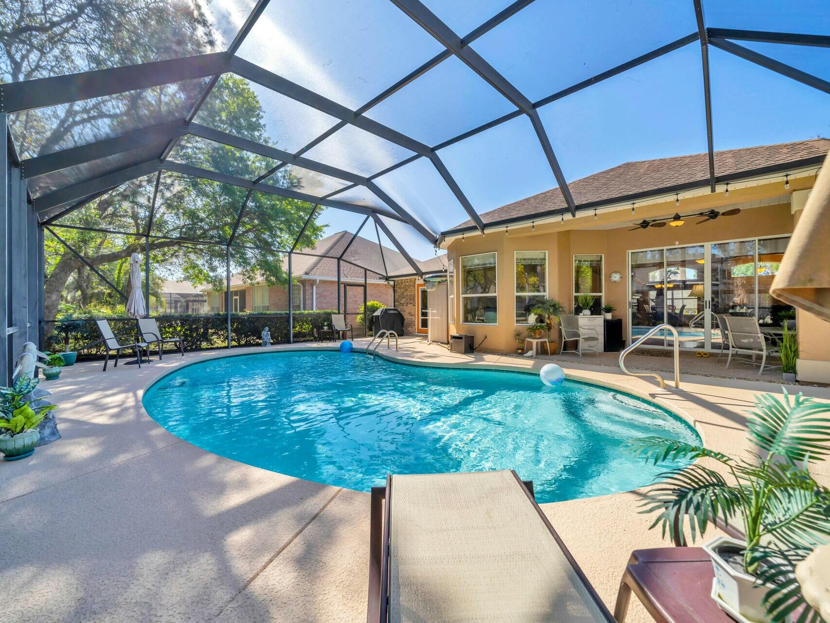Welcome to your dream home in the highly desirable Indian Lake neighborhood! This elegant pool home offers the perfect balance of comfort, style, and convenience- just minutes from shopping, restaurants, and the white-sand beaches of Destin. Soaring 10 and 11 foot ceilings, large windows, and beautiful hardwood floors create an airy feel throughout the main living areas and master suite. Designed for privacy, the split floor plan separates the master bedroom from the guest rooms. Retreat to a spacious master with a walk-in closet and a spa -like bathroom featuring double vanities, a whirlpool tub, and a separate shower. The modern kitchen is outfitted with sleek stainless steel appliances and pull out drawers perfect for home chefs and entertainers. Gather in the cozy living room around the gas fireplace and enjoy easy access to the covered lanai and pool area. The living room and master bedroom open up to the lanai covered pool area making it an ideal space to relax and entertain in any season. Whether you're looking for a full-time residence or a coastal getaway, this home checks all the boxes.