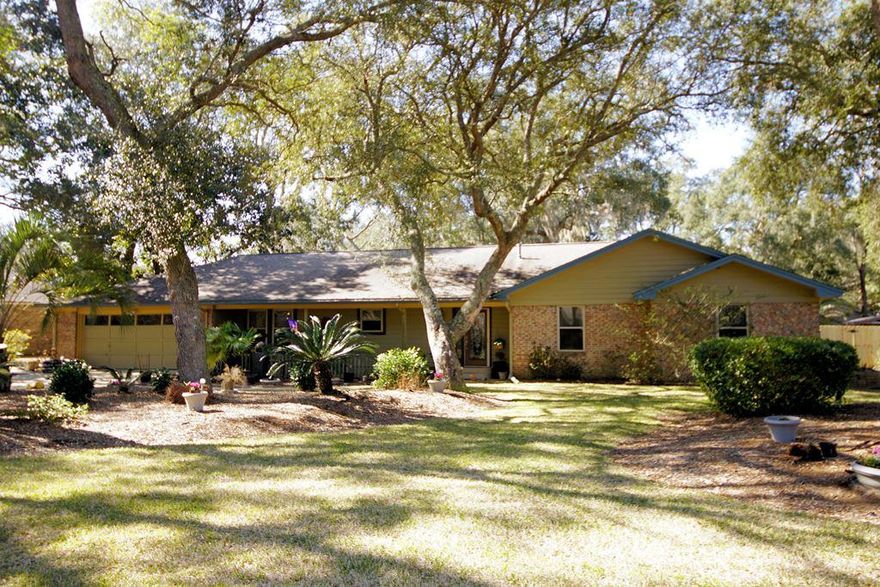 Wonderful home with a large enclosed pool on a lushly landscaped -1/2 acre lot in one of the finest communities in Bluewater Bay, Lido Village. This all brick, beautifully updated, 1-story home also features a 484sf Florida room (heated byt not included in SF) along the back of the house overlooking the sparkling pool. All of the living areas of this home are tiled for easy maintenance. The updated galley kitchen features a convenient breakfast bar as well as a charming breakfast nook. The dining room off of the kitchen is open to the oversized family room that leads to the Florida room. Both of these rooms are large and can accommodate oversized furniture. The master bedroom has a sliding door leading to the Florida room and the master bath has been completely renovated to include a large