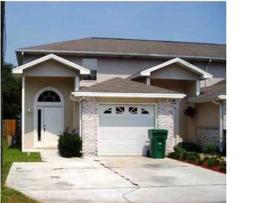 This townhome has been renovated to the max! New paint, stained concrete floors throughout entire downstairs,upgraded ceiling fans w remotes and light fixtures, the kitchen has been updated with all stainless steel appliances, the cabinets are black and they go perfectly with the granite countertops, did I mention that it has a breakfast bar too? Going upstairs you'll find dark wood flooring on the steps and it continues throughout each bedroom upstairs. Both bedrooms have their own private bath and there is a half bath downstairs. The backyard is very spacious and includes a storage shed. There is an indoor laundry room and a one car garage plus a double driveway for extra parking. Don't miss out on this incredible home!