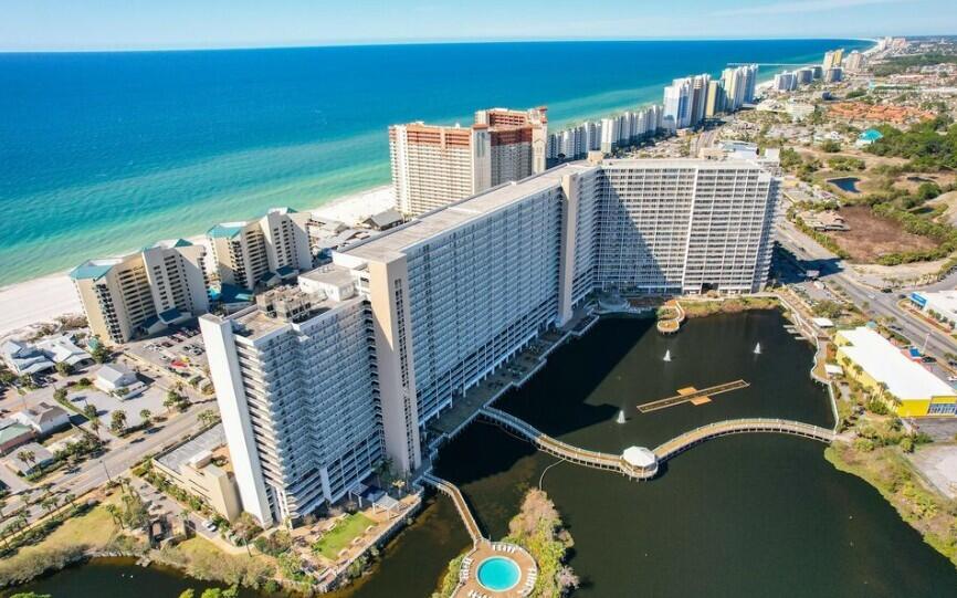 Welcome to Unit 1403 at Laketown Wharf - Your Fully Furnished Beachfront Retreat! SELLER FINANCING AVAILABLE!Owner is offering seller financing for $50,000 with favorable terms. Great opportunity for qualified buyers. Contact listing agent for full terms and conditions.Enjoy resort-style living in the heart of Panama City Beach with this beautifully maintained and fully furnished 1,047 sq ft condo on the 14th floor of the highly sought-after Laketown Wharf. Boasting stunning views, stylish coastal decor, and spacious living, this turnkey unit is ideal as a second home, vacation rental, or full-time residence. Inside, you'll find an open-concept layout with a large kitchen featuring granite countertops, ample cabinetry, and a breakfast bar perfect for entertaining. The living and dining areas flow effortlessly onto your private balcony- ideal for catching breathtaking sunsets and enjoying the evening fountain light show. The primary bedroom includes an en-suite bath, and there's a cozy bunk area for guests or the little ones. Laketown Wharf offers an unparalleled list of amenities, including: * 5 Resort-Style Pools * 2-Story Fitness Center * Pickleball Court & Putting Green * Grilling Areas & Picnic Gazebo * Onsite Restaurants & Bars * Boardwalk Along the Lake * Owner's USPS Mailroom * 24-Hour Gated Security * Pet-Friendly for Owners The COA fee includes: + Insurance + Water, Garbage, Pest Control + Cable & High-Speed Internet Location is everything and Laketown Wharf places you in the center of it all. You're steps away from the beach with private beach access, and just minutes to Pineapple Willy's, Ripley's Believe It or Not, mini golf, shopping, dining, and family-friendly attractions. Whether you're looking to invest or simply enjoy the Florida lifestyle, Unit 1403 delivers value, comfort, and convenience in one of PCB's premier resort communities.