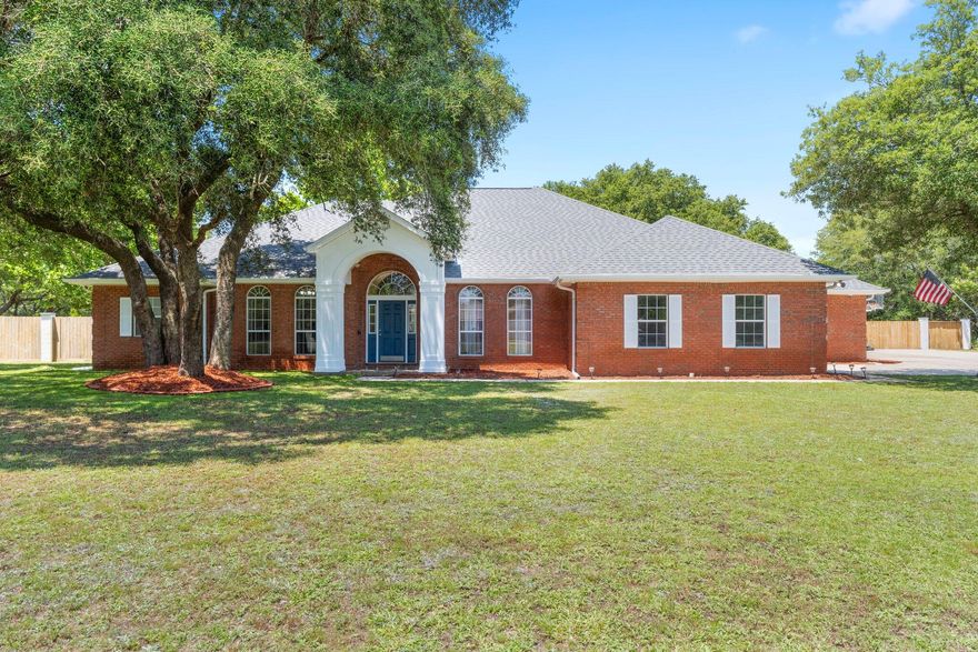 This is your chance to own your slice of paradise just minutes from Navarre Beach. This brick home features an impressive 3,414 sq ft of living space and over 1,000 sq ft of garage space and sits on a unique 1.3 acre property with no HOA! Bring your RV or boat! Inside you have 12 and 9 foot ceilings, formal dining room and office, large island in the kitchen and a breakfast nook overlooking the impressive living room with a fireplace. Master suite has 2 walk in closets, huge bathroom with whirlpool tub and large walk-in shower and a second water heater for the master. The split floor plan offers 3 more bedrooms on the opposite end of the house. An impressive sized sun room, walk out to your huge, fully fenced back yard, detached garage, storage shed, custom playset, gazebo and more!