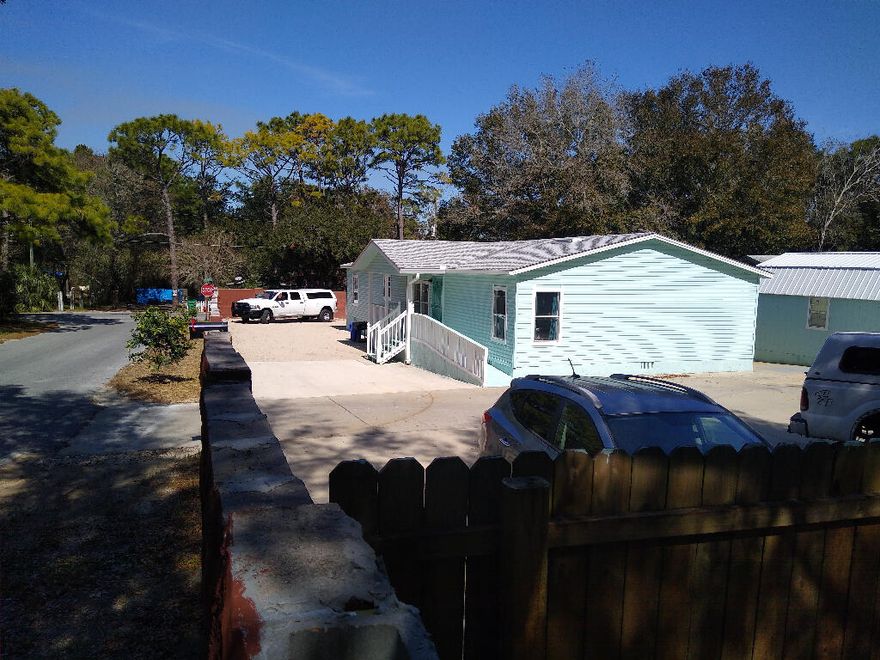6' wall, privacy, park like setting yet 3 blks to Publix, home Depot and 5 miles to Gulf, quiet star gazing nights on .26 acre, new roof, cabinets, baths, kitchen, real hardwood floors, 298 annual taxes, property extends further than fences, no immediate neighbors, 18' gate, rv parking, lots of room for 2040' shop if needed, vaulted ceilings, 6'4' granite Island with power, put in granite counter tops. THE PERFECT BEACH VACATION HOME FOR LARGE PARTIES. Can park equipment, Business allowed to operate here/County, new double door Fridge/Samsung, Faucet, can have granite installed for 1,000, White Oak hardwood throughout, custom complete new baths, 6' + privacy block wall, landscaped, new roof, Back man cave, 300. Tax last year homesteaded, New Nickel light