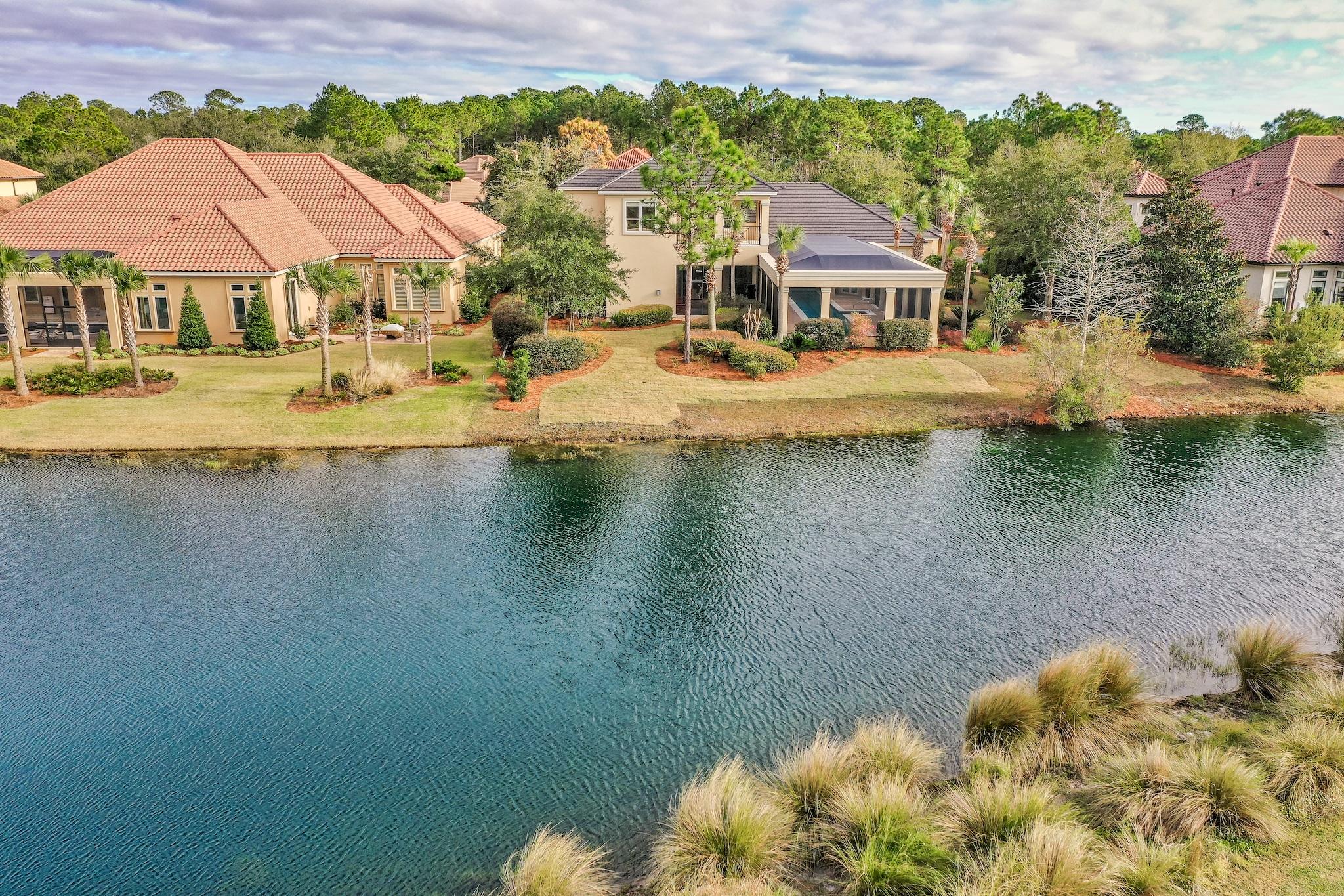 Light-filled, transitionally designed, lakefront home on the 9th fairway in one of the area's most sought-after communities Burnt Pine at Sandestin. A newly updated screened-in lanai with 50-ft lap pool and summer kitchen is a standout among neighboring homes. Designed to maximize space, this home utilizes strong floor plan economy with an arrangement that is intuitive and gracious with high volume ceilings and master suite on main. A cohesive blend of traditional and contemporary design elements is on-trend yet timeless. The modern gourmet kitchen features flat panel, birch cabinets, Euro-style range hood, 2 dishwashers, center island with prep sink, double ovens, and seating. An expanse of retracting glass in the family room opens to the lanai, seamlessly merging the spaces together.