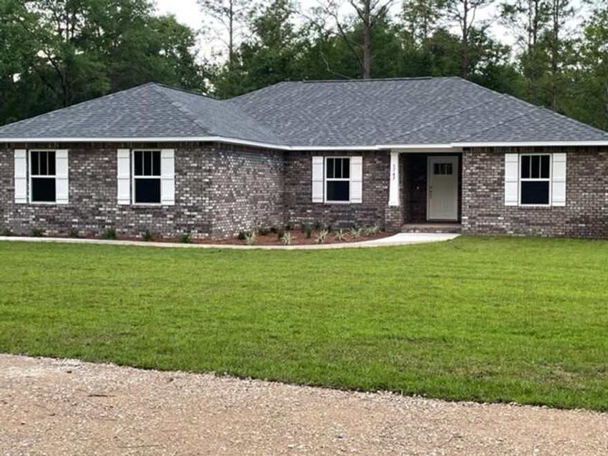 This RARE FIND,  minutes from Town, shopping, Schools, employment - Turn down the LONG (220')  intentionally curved, rock covered drive,  to this hidden gem!   All brick,  4 BR, 2 BA. 2 Car, side entry Garage home with many custom features - like Cathedral Ceiling in Living Room, Trey Ceiling in Master Bedroom, 5-1/2'' Baseboards, All Windows encased with 3-1/4'' trim, ceiling fans in all rooms and on great covered back porch!  Marble bathroom fixtures, Solid Wood Cabinetry with Granite Tops, Kitchen and Baths - Separate Shower in Master Bath with nice soaker tub, double sink vanity, large walk-in closet.   All flooring Luxury Vinyl Plank. Front and Rear Posts 'Craftsman Style'  with Brick bottoms, wood encased top.    Builder ran underground utilities  from Street to house for Aesthetics,