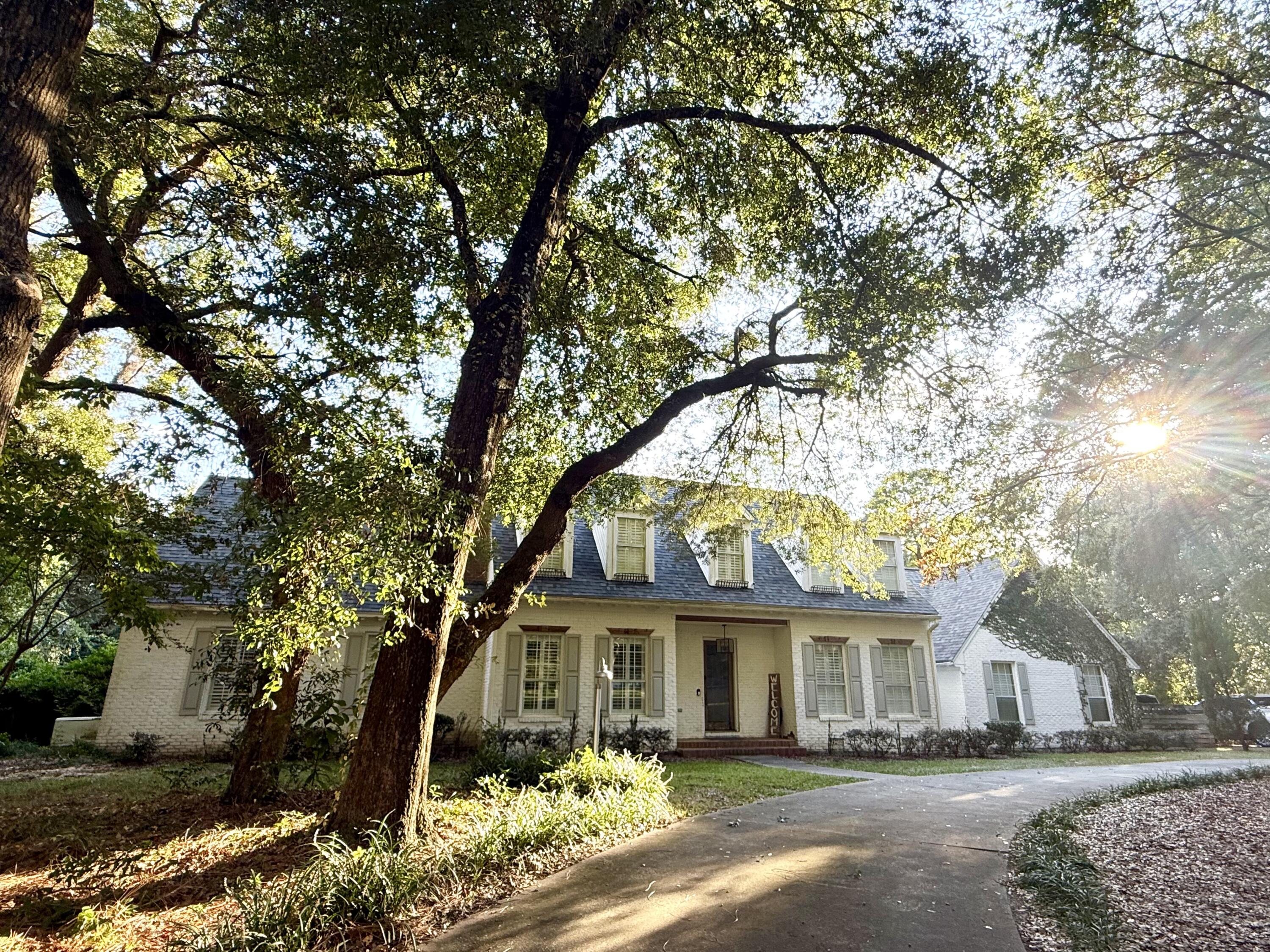 Welcome to 2624 Edgewater Drive in Niceville's Rocky Bayou on the Bayou community. Set on well over an acre and shaded by mature oak trees, this home offers privacy, charm, and community access to a bayfront lot for sunsets, paddleboarding, or relaxing by the water.The property features a screened 40,000-gallon pool with a new three-phase pump, two large deck areas, a koi pond, and a rose garden. Inside, hardwood floors extend throughout, complemented by custom shutters and generous custom closets. The open layout provides both comfort and function, ideal for daily living and entertaining. Also property is on one of the largest lots at 1.11 acres. You can potentially do a lot split and build another house or just sell the lot out right! Solar panels add efficiency and savings, Keeping the average power bill around $280 per month! Additional updates include a sealed air duct system, new roof (2022), 4-ton AC (2021), new garage doors, and a whole-home Generac generator, delivering lasting value and peace of mind.