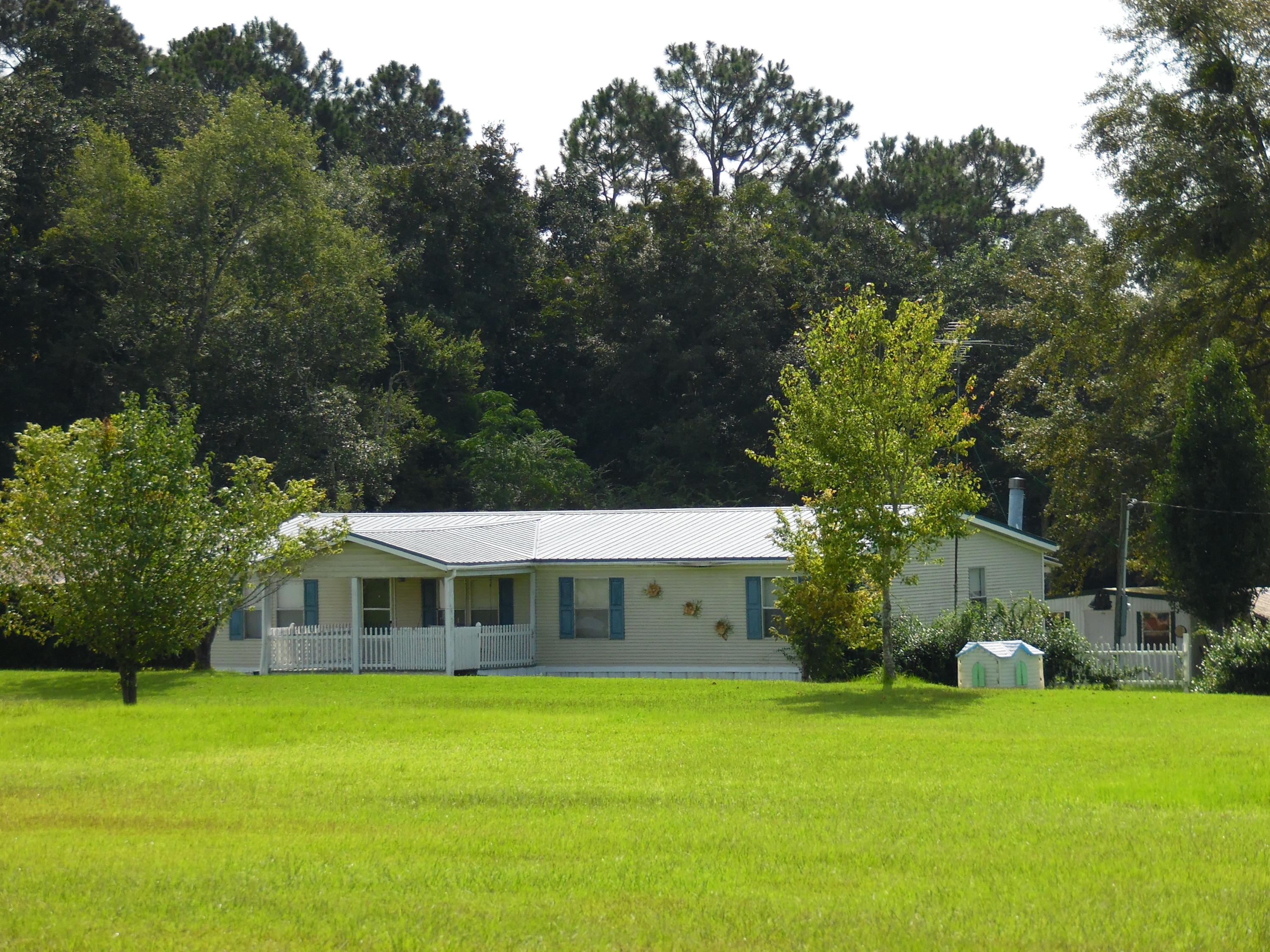 Beautiful country setting with this 1998 manufactured home with 3 bedrooms, 2 baths, double car carport on 12.11 acres zoned agriculture. Most of the property is cleared and ready to fence for horses. Back porch on front and back of home.