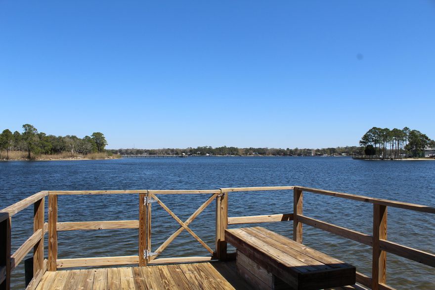 Waterfront at it's best! This charming mid-century modern is sure to please with great water views of Boggy Bayou. The interior of the home has just been completely painted and the seller has just had new carpet installed. From the living room and dining area you will notice the large open windows that fill the home with natural light. The family room at the back of the home is quite large and looks out to the back yard. Speaking of the back yard, it's the perfect place to entertain under the shade of the majestic live oaks. There is also a large workshop that will convey with the property. Across the street you will find the boardwalk to your boathouse and dock. There is currently a covered motorized lift as well as an open dock area for fishing or sunbathing.