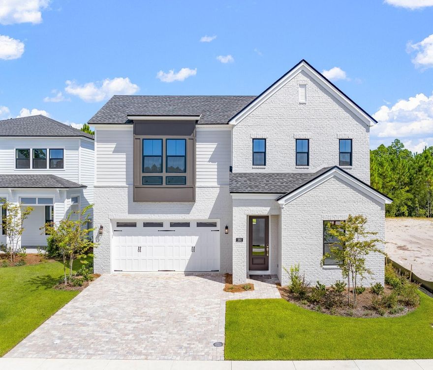 This exquisite brick-front two-story home perfectly blends tranquility and warmth, offering a welcoming retreat from the moment you arrive. The elegant paver driveway guides you to a charming front door, setting the tone for the beauty that awaits inside. Upon entry, the dramatic two-story foyer greets you, leading into the airy great room with its striking tray ceiling and an abundance of natural light. This space effortlessly combines grandeur with comfort, creating the ideal setting for both relaxation and gatherings. The open gourmet kitchen has sleek quartz countertops, a large island with thick waterfall quartz on the sides, a designer tile backsplash, and stainless-steel appliances, including a 5-burner gas cooktop, a vent hood, a built-in microwave/oven, and a dishwasher. The first-floor primary suite is a serene retreat, offering comfort and luxury. The walk-in closet provides ample storage, while the dual vanity with quartz countertops combines beauty and functionality. The large tile shower creates a spa-like experience, adding a touch of relaxation to your daily routine. Upstairs, the versatile loft offers endless possibilities, whether as a home office, cozy living space, or play area. Covered paver lanai with views of a private wood preserve, this home offers a serene oasis for outdoor enjoyment. New construction and available for quick move-in.