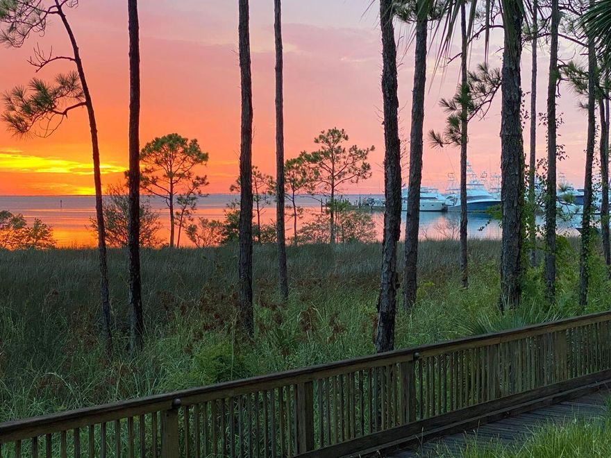 Enviably located overlooking panoramic views across Choctawhatchee Bay, this exceptional four-bedroom condo at The Anchorage is a rare find. Offering all the conveniences of condo living, this well-designed property also has a sought-after garage and a private fenced yard overlooking the bay. Quality is apparent from the outset with cool Travertine tile floors, solid core doors, custom woodwork, plantation shutters and fresh decor. The open living area and bedrooms deliver panoramic waterfront vistas that extend across the tranquil bay from Baytowne Marina to Mid Bay Bridge. The master suite includes a walk-in closet and spa-like ensuite bathroom with a whirlpool tub while guest bedrooms all have en suites and access to a lanai. The updated kitchen will inspire chefs with its stylish