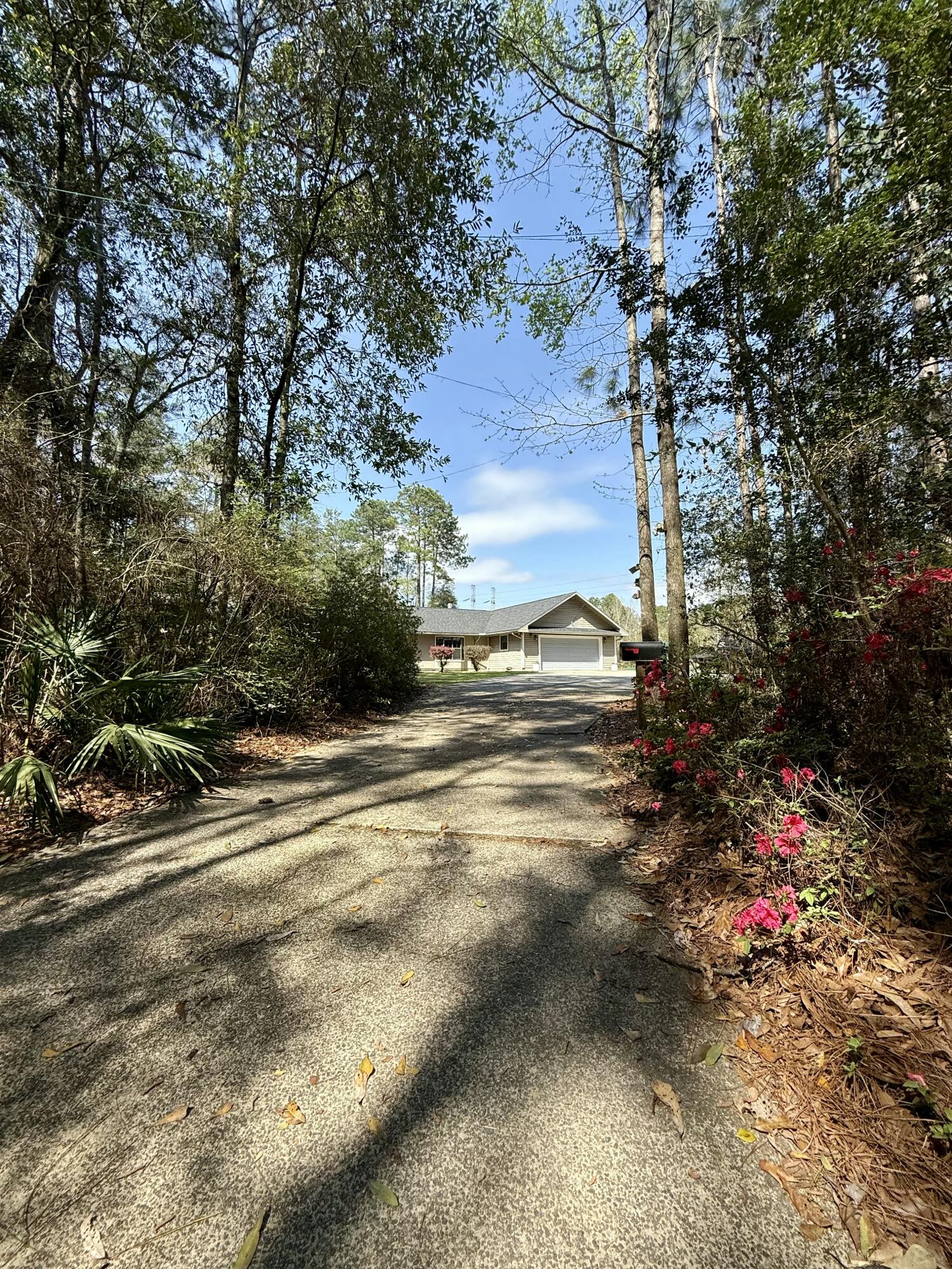 MOTIVATED SELLER! South Crestview gem offers peaceful country living on 2.53 private acres! Spacious main home features 4 bedrooms and 2.5 baths, including a large master ensuite with a relaxing jacuzzi tub. The 4th bedroom could be perfect as an office, playroom, guest space, or craft room. Open kitchen layout includes granite countertops, stainless appliances, a farmhouse sink, and an oversized island with gas cooktop. The large great room features a wood-burning fireplace and is perfect for gatherings. Enjoy the screened-in porch, and outdoor retreat with patio, fire pit, 40x30 workshop, 20x28 pole barn, & chicken run. Bonus: A private apartment with two entrances--great for guests, working from home, or rental income. Easy drive to Duke field & Eglin! Schedule your showing today!