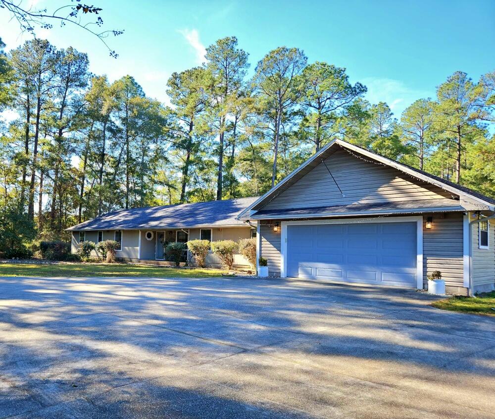 Priced at recent appraisal value! Country living in South Crestview! Spacious home on 2.53 acres offers privacy and plenty of room indoors and out. Open floor plan. Kitchen has granite countertops, stainless appliances, farm style sink, cabinets galore, large island with a gas cooktop. Screened porch off the dining room. Great room features a wood burning fireplace and built-ins. Step out the back door to your private oasis including patio, fire pit, 40x30 workshop, 20x28 pole barn and a chicken run. Separate apartment along the back of the garage with two entrances is perfect for an office, hobbies, guests or potential INCOME producing with a tenant. For your peace of mind, seller says: 'Home inspection was done and all suggested repairs and modifications have been made'