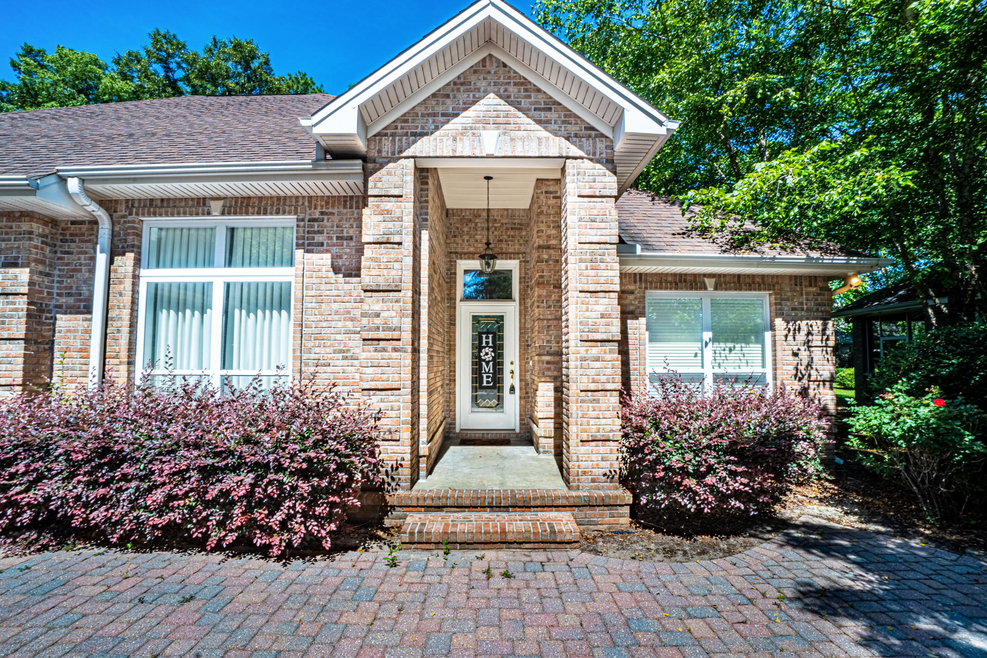 This executive home has over 3,800 sq ft of versatile space, and can be used as a 5 BEDROOM. In the GATED community of Claire's Vineyard, first impressions count: lush landscaping and a brick paver horseshoe driveway lead to a stately pillared entryway and THREE car garage. Throughout the home, take note of details such as recessed lighting, crown molding, and tray ceilings. Upon entering, there are two bedrooms and a full bathroom and an oversized bonus room, currently outfitted as a media space. In the center of the home is a spacious living room with a gas fireplace.