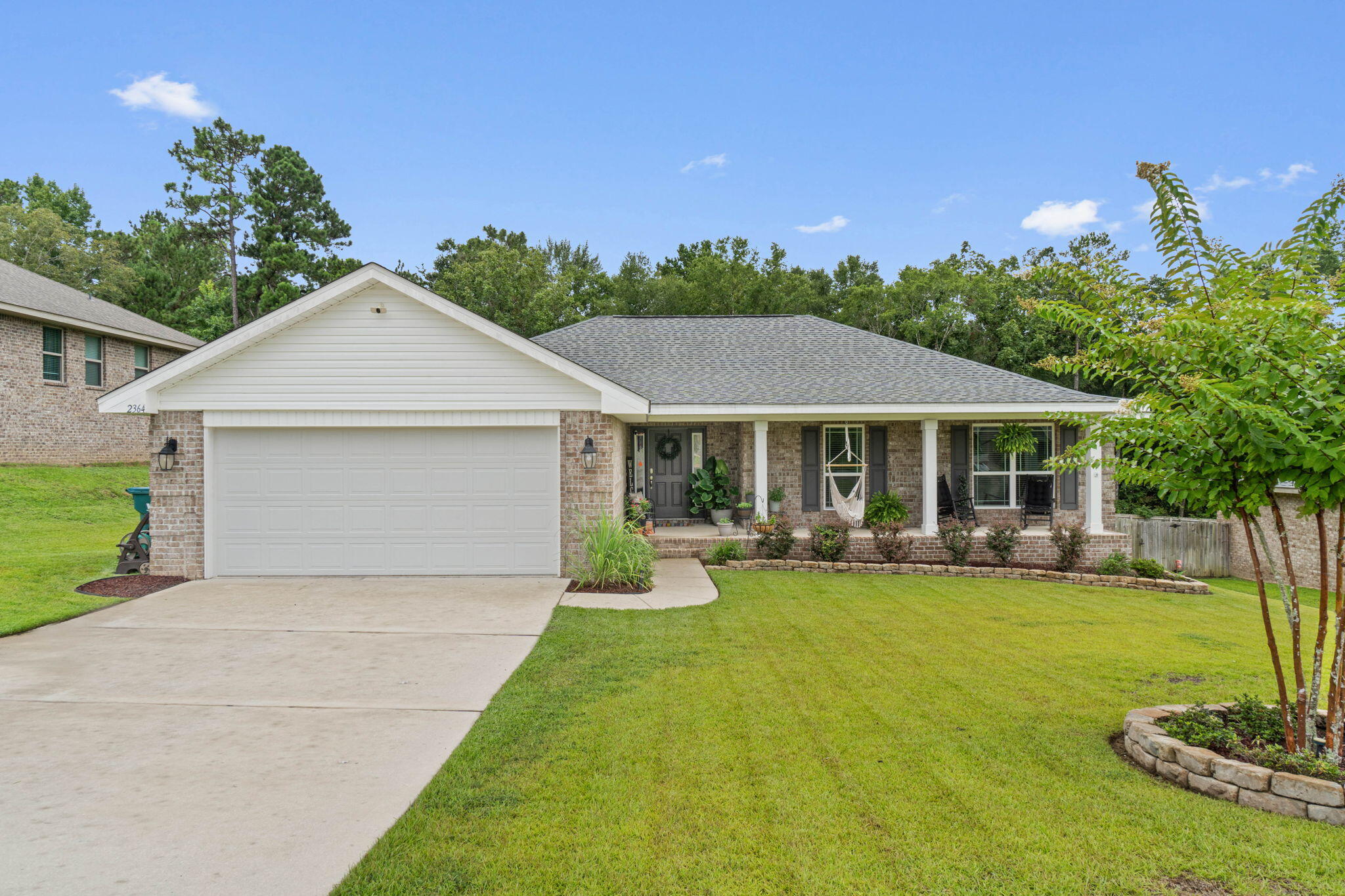 Welcome to this charming newer-built home offering 1,920 square feet of thoughtfully designed living space! Step inside to discover beautiful board and batten walls, custom accent walls, and upgraded light fixtures throughout. The kitchen shines with granite countertops, stainless steel appliances, and stylish backsplash. With 4 bedrooms and 2 bathrooms in a split floor plan, everyone gets their space. The primary bedroom features its own en suite and sits quietly at the back of the home. Outside, enjoy the fully fenced backyard with sprinkler system, fire pit, and a fun custom slide with rock-wall off the deck. This all-brick home comes with paid-off solar panels and seller assistance with closing costs!