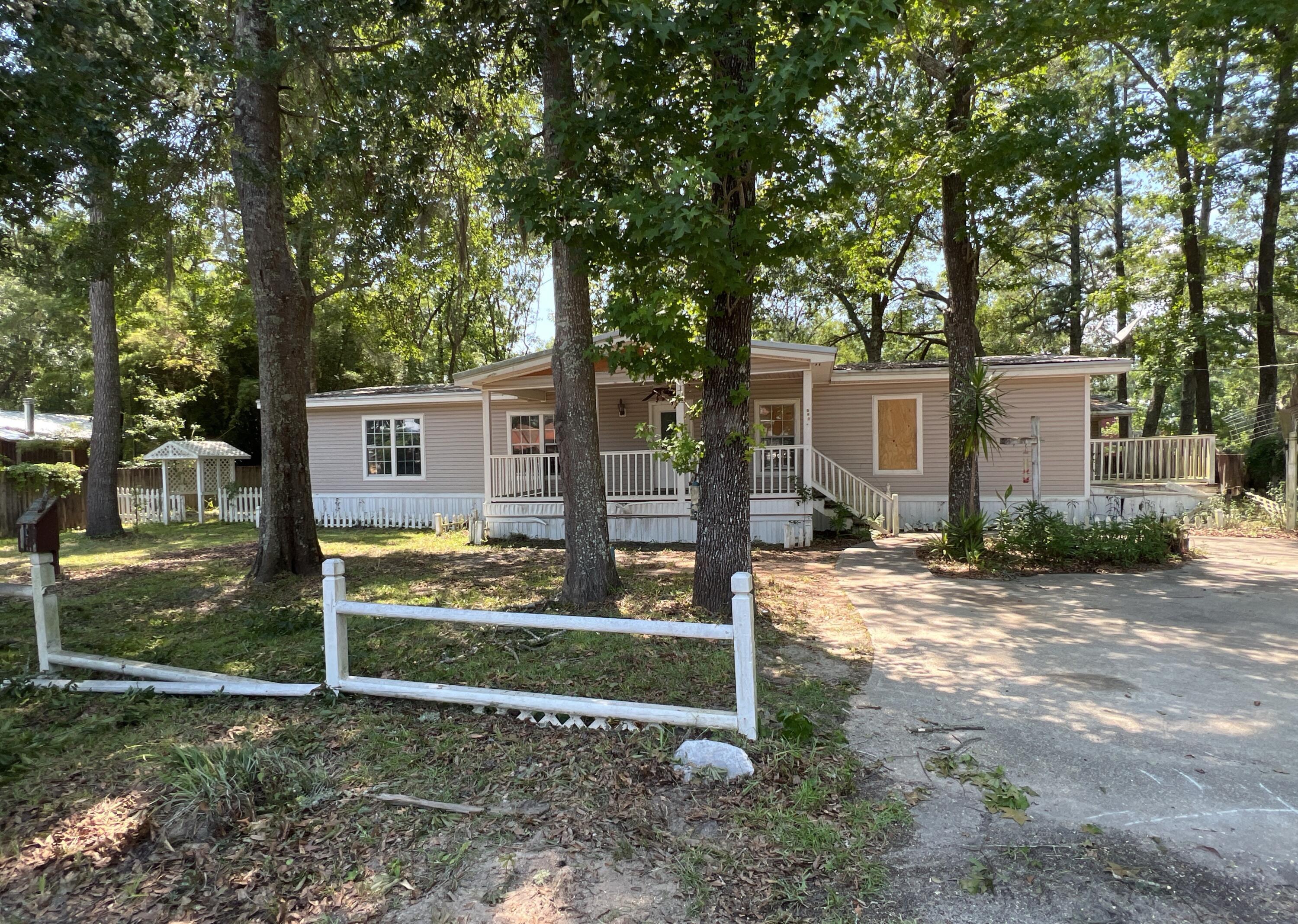 River camp life with this 1664sf REO Mobile Home. built in 1986, this split bedroom 3 bedroom 2 bath home has large living room with fireplace, separate dining area, large covered porch and deck and detached mother-in-law Apartment. This home rests on approximately .27 acres and is does need significant work and will not qualify for financing. Cash only. Call today!