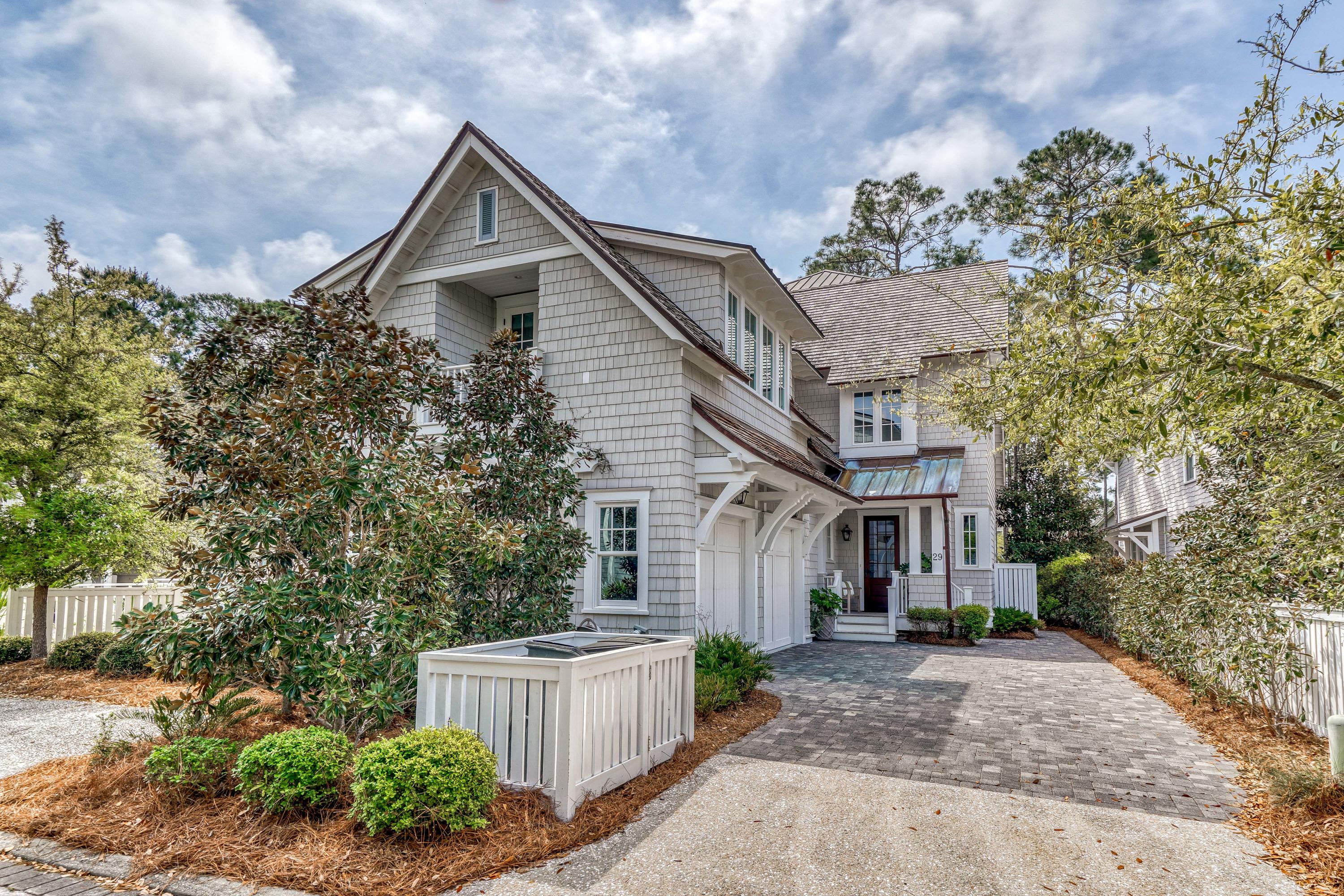 Find a cultivated palette of soothing neutrals & earth tones at this stunning WaterSound Beach residence. An elevator allows access to all three levels of this beautifully designed property. Multiple outdoor spaces including both screened & covered porches, a summer kitchen & a tower deck are the perfect spots to unwind.  The open living area features coffered ceilings with white beams & rich wood panels, a cozy fireplace with charming brick surround & custom built-ins. A large center island that seats six people is the heart of the gourmet kitchen with marble countertops, three sinks, custom cabinetry & professional grade appliances including both wine & beverage refrigerator & icemaker. The light-filled dining area offers plenty of seating including a banquette.