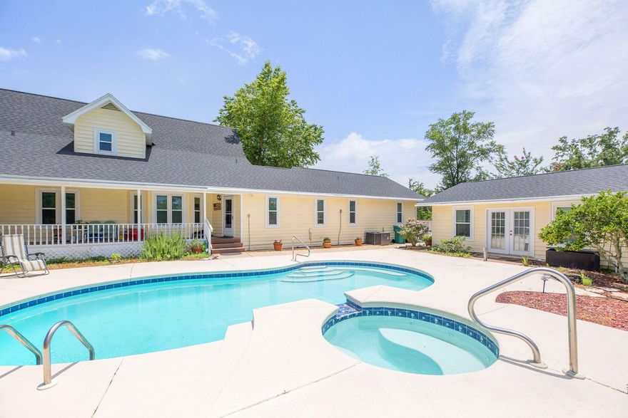 Country charm, room to sprawl, and tranquility collide on this 2.5 acre home in Southport. The inside of this 4 bedroom 3.5 bathroom home boasts an attached mother in-law suite with separate entrance, a main floor master bedroom, large office with built in bookcases, and oversized formal dining room. Additionally, the spacious kitchen contains all stainless steel appliances, granite countertops, large island and sizable pantry. Outside the home you can utilize and enjoy the large covered front and back porches, private in-ground pool and hot tub, pool house, barn with covered parking, two sheds, a utility shop, 50 amp service for your RV/camper, a chicken coop, multiple fruit trees, wild grapes and blueberry/blackberry bushes! The central location cannot be beat with only a 20 minute drive to the airport, 10 minutes to downtown Lynn Haven and 30 minutes to Tyndall Air Force base or the World's Most Beautiful Beaches! Don't miss out on this move in ready home with all the space you could need.