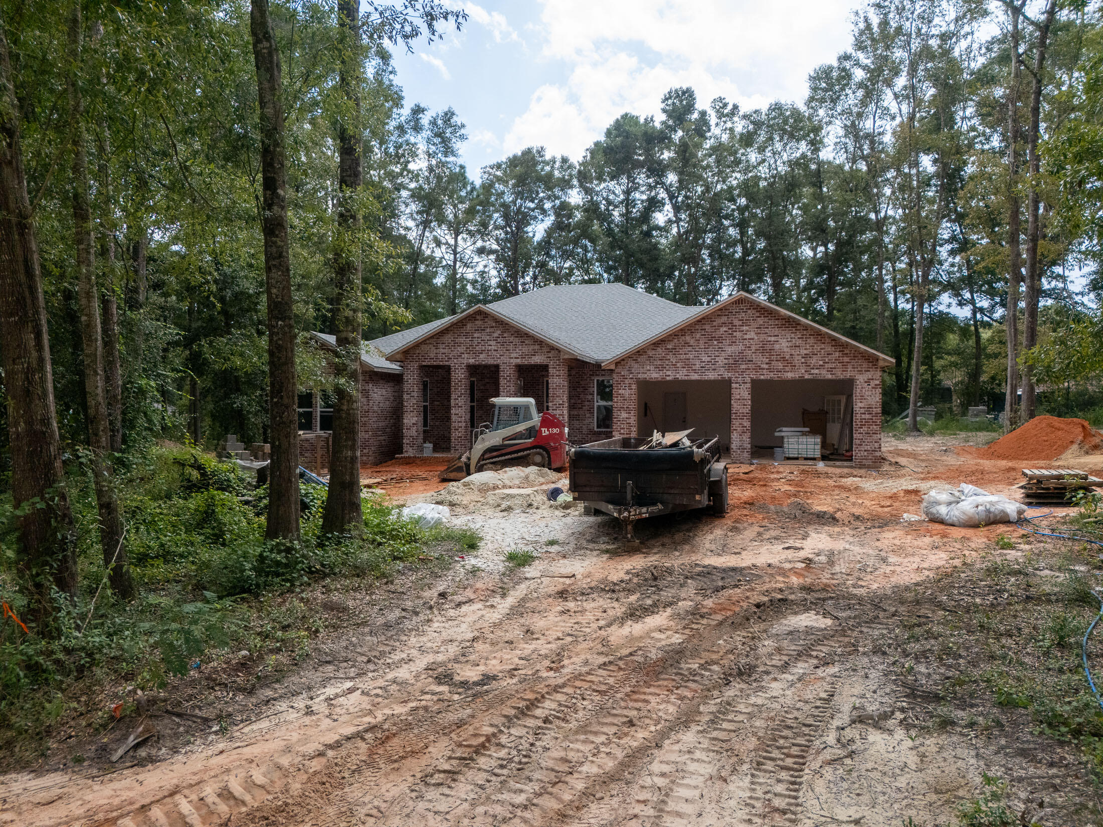 No HOA in this well established neighborhood with blue water Lake Juniper views. This custom new construction brick home is nestled on a large wooded lot at the end of  the cul-de-sac, with all the updated farmhouse style and charm you'd desire. Upon entry, the foyer is styled with a barrel vault pine tongue and groove ceiling, with sconce lighting and columns, perfectly planned to display art or precious family photos. Next, opening up to the great room, you'll find tons of light from the windows framing the sizable back yard, with more tongue and groove ceilings, this time vaulted. Each space is generously sized for comfort. From the well appointed kitchen with raised breakfast bar, gas range, the newest in stainless steel appliances and a double pantry between the kitchen and utility room. The colors and textures blend seamlessly with neutral hues in the durable engineered bamboo flooring, except in tiled wet areas. The dining area comfortably seats 8, taking in the back yard views (or your future pool). A classic and family friendly wet bar is conveniently located adjacent to both the dining and living rooms. Next, the roomy master suite is a true retreat, including striking trey ceiling, complete with ambient lighting. The master bath embodies luxury, with double vanity, quartz counters and no amenity forgotten: soaking tub, fully tiled large walk-in shower, water closet and expansive walk-in closet with custom built-ins. The additional 3 bedrooms are generously sized, as are the additional 2 full bathrooms. Flanking the great room are 2 multi-functional rooms, which would be perfect as his and hers home offices; or could easily serve a multitude of purposes, only limited by your imagination. The attic has foam insulation for superior efficiency. The back yard has plenty of room for a pool and has a naturally wooded border on 2 sides for privacy. If you're looking for top notch construction, all the proverbial bells and whistles, in a fantastic location with lots of space inside and out, this one is not to be missed. *Note: pictures are from a previous build. A few minor things have changed/been improved from the photos. 