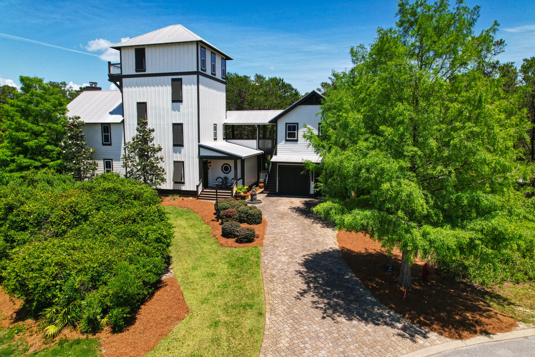 UNDER CONTRACT, ACCEPTING BACKUP OFFERS.  Come see this stunning, custom-built property ideally situated within the highly desirable Grande Pointe community.  Sitting on a large corner lot that backs up to Camp Helen State Park, this expansive 4 story, 5 bedroom home features an elevator and boasts a large mother-in-law suite fully contained above the garage.  Inside the residence you'll find numerous features.  The second floor master suite offers a walk-in closet, separate dressing area, private bath w/ double vanity and a private balcony overlooking the state park.  Downstairs you'll find an open kitchen that flows into the living and dining area.  If you want to host and relax outdoors, there is a large screened porch complete with a wet bar and fireplace.
