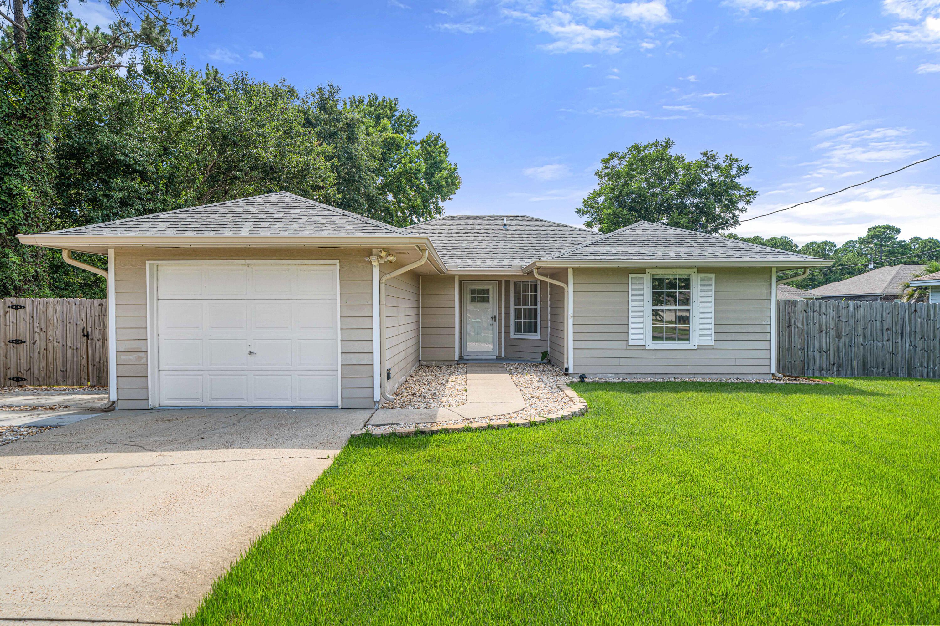 Totally remodeled and just minutes to the front gate of Hurlburt Field and only a 30 minute drive to Eglin AFB. This gem is a perfect primary residence, second home, or investment property! Have peace of mind with a roof just replaced November 2022, new HVAC in 2019, and a water heater replaced December 2018. Pull up to this adorable west Mary Esther home and walk inside to find a beautifully updated home. Wood look tile floors greet you and extend through all the common areas and a vaulted ceiling in the spacious living room adds to the fantastic open floor plan. You'll love this kitchen with granite countertops and room for bar stools and a breakfast nook, soft close white shaker style cabinets, separate pantry, and stainless steel appliances including a low profile microwave and a smar smart fridge! Primary suite on the back of the home overlooking the beautiful yard. Great layout with 3 bedrooms, 2 bathrooms and a 1 car garage! Washer and dryer included too. Lots of updates outside too! Extended driveway with room for an RV, boat or just extra parking. In the back there is a new screen porch that adds a great space for bird watching, enjoying the breezes and entertaining. Beautifully landscaped yard. Home has been treated quarterly for pests and has termite bait stations. This home has all the upgrades at a great price! Move in ready and must see asap!
