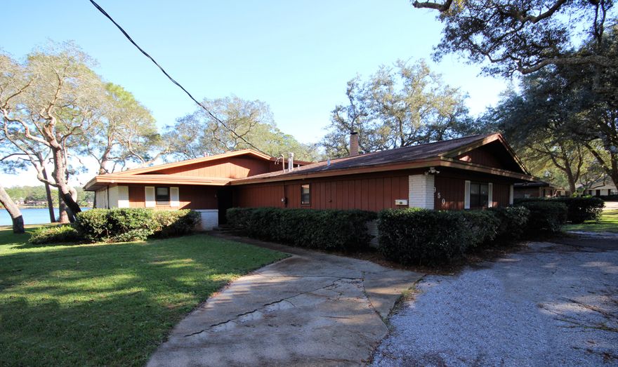 WATERFRONT! Endless possibilities with some TLC....this home is being Sold ''As-Is'''. The home is situated on a beautiful wooded lot with mature trees and can either be renovated or purchase this property and design and build your own dream waterfront home situated on Cinco Bayou with beautiful waterfront views. Please schedule a showing so you can start to envision your future home. Home and All appliances and exterior yard building convey in ''As-Is'' condition.