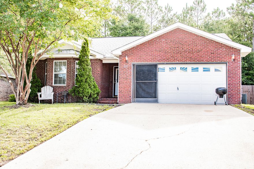 Custom built home. Nicely maintained property with brick front. Open concept kitchen, dining and living room area. Large kitchen with ample cabinet and food prep space. Wood-look flooring throughout hallways and living room. Adjustable screen enclosure for the garage. In the back yard you will find a privacy fence and a storage shed that conveys with the property. Located directly behind the privacy fence is a wooded tree line of undeveloped land giving additional privacy. No HOA!