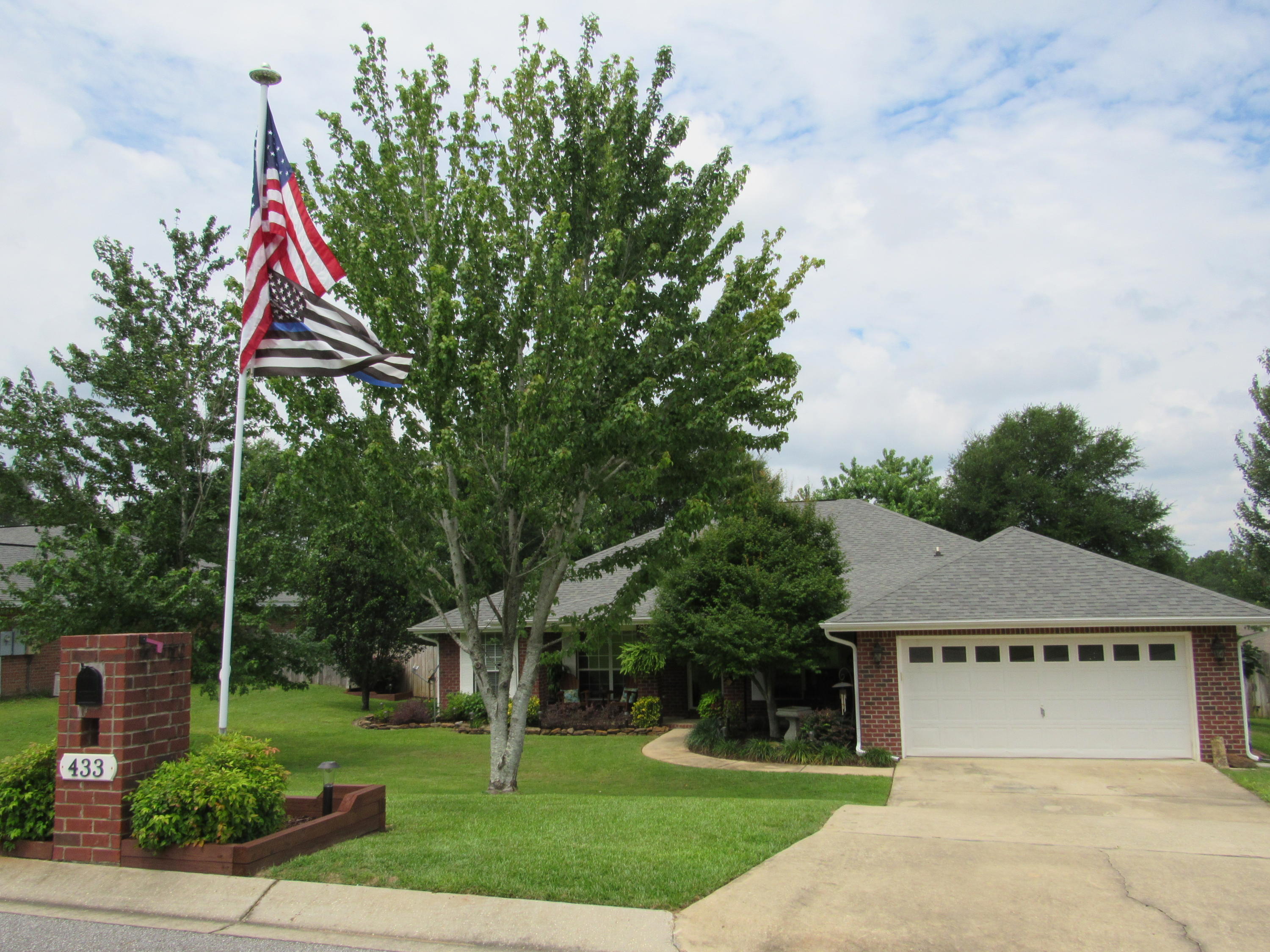 This home is for you and no need to look any further! Beautifully maintained all brick home with gutters that speaks the pride of ownership. Sit and enjoy the large country front porch and admire the beautifully landscaped yard. The tiled entry invites you into this gorgeous home, with vaulted ceiling in the living room. Laminate flooring is in the living room, dining room & hallways. The living room has ceiling fan, vaulted ceiling, wood burning fireplace with brick & tile surround & a custom-made mantle. The kitchen features tiled flooring, breakfast nook, stainless steel appliances to include, range, microwave, dishwasher & side by side refrigerator, spacious pantry and an abundance of cabinets and countertops. The formal dining room has laminate wood flooring & nice chandelier.