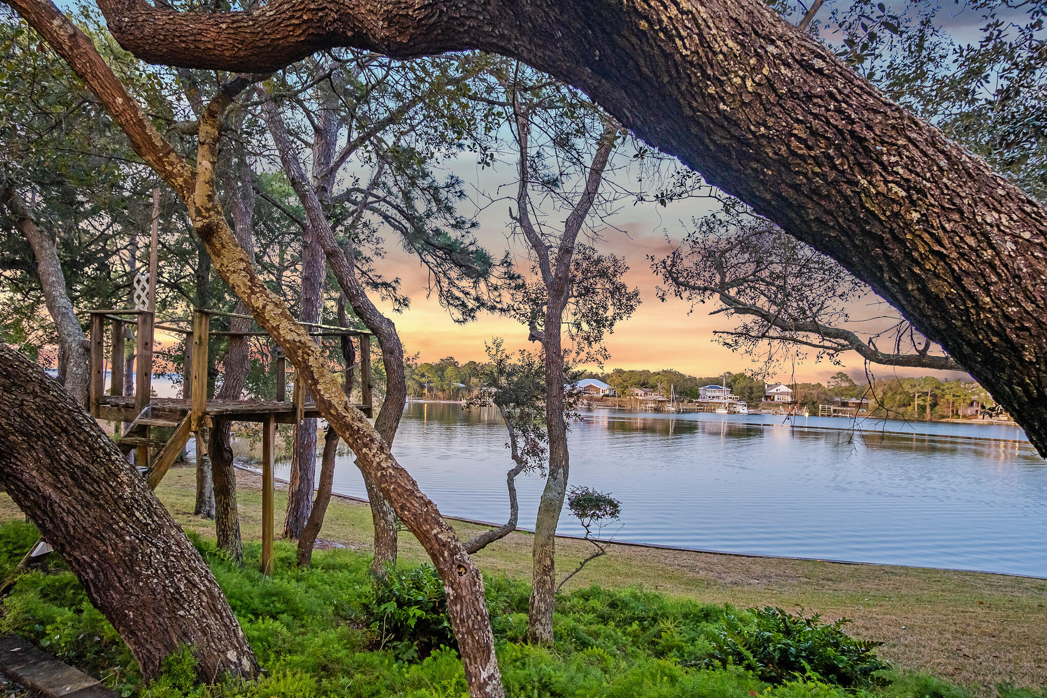 **Exquisite Waterfront Oasis on Joe's Bayou - No HOA**Experience the epitome of waterfront living with this breathtaking estate that graces a vast .87-acre peninsula point lot, boasting an impressive 657 feet of prime water frontage on Joe's Bayou. Fresh from a meticulous renovation, this property presents an unparalleled opportunity to own a slice of paradise with deep water access and a newly constructed boathouse, ready to accommodate your boating adventures.This listing is also available at MLS #962866717 6th StreetDestin, FL 32541 **Home Features:**
- **Expansive Living Spaces:** Amidst this majestic setting sits a beautifully renovated home encompassing four generously-sized bedrooms and three full bathrooms, offering comfort and luxury for family and guests alike.
- **Panoramic Water Views:** Revel in the serenity of water views from every corner with vast windows throughout the home, ensuring an abundance of natural light and breathtaking vistas of the bayou - a feature that truly sets this property apart.
- **Potential Unleashed:** An enticing, unfinished third story awaits your vision, presenting the perfect canvas to add an additional bedroom, entertainment area, or whatever your heart desires, further enhancing this home's appeal.
- **Outdoor Paradise:** The estate's sprawling grounds are as opulent as its interiors, featuring a lush, verdant landscape that ensures utmost privacy and tranquility. The panoramic 270?? water views offer a constant reminder of your exclusive sanctuary.

**Additional Luxuries:**
- **Expansive Parking & Garage:** Accommodate guests with ease, thanks to ample parking space for over ten vehicles and a sizeable three-car garage.
- **Unrivaled Privacy & Security:** A security gate guards the entrance to this secluded haven, nestled amid dense greenery and natural beauty, ensuring peace of mind and privacy.

**Ideal Location:**
- This stellar property is not governed by an HOA, granting you the freedom to customize your living experience without constraints.
- Its strategic placement on Joe's Bayou not only provides stunning views but also ensures easy access to water activities directly from your backyard.

Whether you're a boating enthusiast eager to explore the waters or someone seeking a tranquil retreat surrounded by nature's beauty, this exquisite property promises to be a haven of luxury and serenity. Don't miss the chance to own this unique waterfront estate, where every day feels like a vacation.