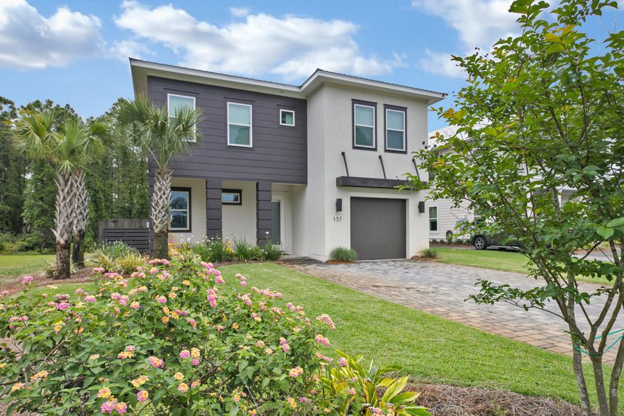 This isn't your cookie cutter developer home! It was a custom home built to maximize fun! It  has been lightly used as a corporate retreat, but could be a rental machine! The open floor-plan has beachy -meets-industrial decor with a polished concrete floor, makes entertaining and vacationing easy. Enter downstairs  to a dramatic living area with a 20' ceiling. The great room offers plenty of natural light and top line furniture, then walk into a gorgeous modern kitchen with quartz countertops, stainless appliances, and a large island. The generous master offers his & her closets, a luxurious master bath and oversized walk in shower.  Upstairs, there is another master bedroom and 2 additional very large bedrooms. There is ample room to add additional bunks to maximize rental revenue. This home is as private as you get this close to the beach. It is built next to a lake and has a fenced backyard.
This home has 10 & 9 ft ceilings in the bedrooms, 8 foot doors throughout main floor, 2 HVACs, tankless gas water heater, washer & gas dryer, wireless central vacuum w/hide away hoses, 1-car garage, sprinkler system with well, and parking for 5+ cars.

