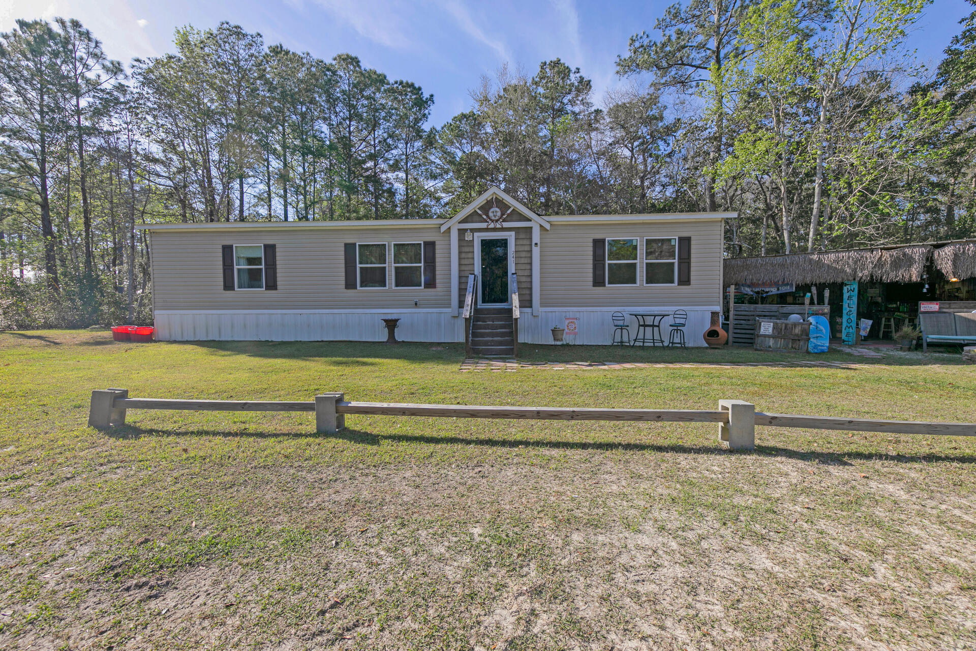 No HOA fees! Beautiful 3 bedroom 2 bath manufactured home located in the Black Creek area of Freeport. This home was built in 2018 and sits on a large 0.5 acre lot. The main living area has beams in the ceiling and an electric fireplace. The kitchen is open to the main living area and features stainless steel appliances. The master bedroom comes with an en suite bathroom that has a garden tub and separate shower. There are two additional large bedrooms that share a second bathroom. All the bedrooms have oversize closets. This home has a wonderful outdoor space for entertaining featuring a Tiki bar and fire pit. There is ample storage on this property, including a 2 storage rooms that will convey with the property. This home is located only 0.4 miles from the boat ramp on Black Creek.