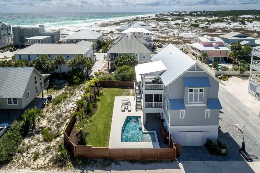 Stunning home in historic Grayton Beach with a private pool, expansive backyard, gulf views and just steps away from the beach. Located on a 100' x 100' lot, the main house (built in 2018) boasts 4 bedrooms, 4 full and 2 powder baths, as well as a recently completed fully-contained first-floor apartment with a kitchen, quartz countertop, living area, bedroom, bath and separate side entry. This gives the home an ideal configuration of 5 bedrooms, 5 full bathrooms and 2 powder baths. The open concept kitchen and living room are located on the second floor and opens to a 12' deep screened porch that runs the full width of the home, perfect for dining al-fresco. Enjoy a chef's kitchen with a farmhouse sink, marble countertops, 48'' Wolf 6 burner gas range, ice maker,