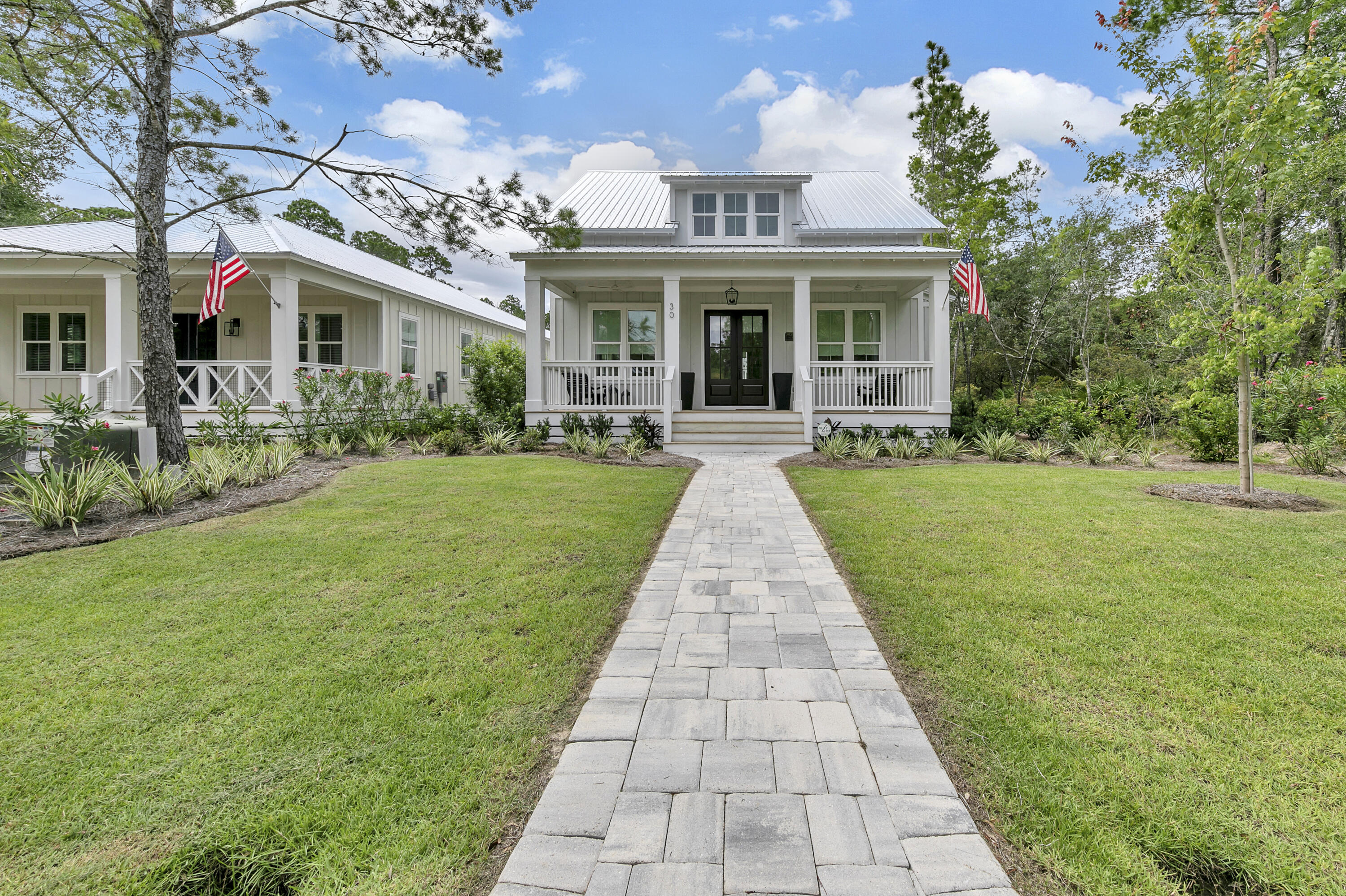 Welcome home to 30 Devlieg Avenue, a stunning custom 3 bedroom/ 3 bathroom with carriage home located in the Grayton Bayou community. As you enter the home, an open airy living and dining room area provides ample space for seamless entertaining. The modern farmhouse open concept home is finished with 10ft wood beam ceilings that lead directly into a chef's kitchen. The stunning and spacious kitchen is completed with quartz counter tops, modern shaker- style cabinetry, farmhouse sink, and top of the line Viking appliances. The main home is comprised of a master suite and a guest bedroom. The serene master bedroom offers a spacious retreat and the master ensuite includes dual vanities, a large walk-in shower, and a walk in closet. A true backyard oasis embraces Florida's outdoor living at its finest. This oasis features an outdoor lounge area complete with a fire pit and TV, inviting back porch area, and an outdoor shower.  In the heart of the backyard, you will find the detached 1 bedroom/ 1 bathroom carriage home complete with a rear two car garage. The carriage home studio offers ample space with an additional living area complete with a full bathroom. Carriage home offers great additional living space or a perfect investment opportunity. You have all you need here to instantly enjoy the Santa Rosa Beach lifestyle! Easily enjoyed as a vacation home oasis, investment property, or your next primary residence.

Grayton Bayou amenities include a neighborhood pool and spa and is within walking distance to the community fishing dock and public Bay front dock. Not to mention, Grayton Bayou is only 5 minutes away from Grayton Beach and all that 30A has to offer! This custom home is a must see, call today to book a private showing! 