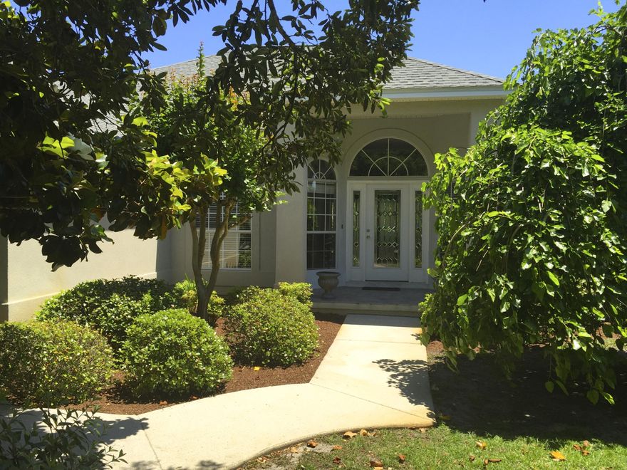 This immaculately kept home is located in one of Navarre's most desired communities, minutes from the Gulf of Mexico and a short drive to Hurlburt Field. An open concept, split floor plan features 3 bedrooms, 2 baths den,/study , formal dining room, large family room, and kitchen with eat-in area. Among the many features in this home: beveled glass front door, arched windows, vaulted ceilings, gas fireplace, updated kitchen with stainless appliances, plant ledges, walk-in closets, a new heating/AC system, tiled covered patio and luscious landscaping. Located just steps away from a deeded beach access and community gazebo overlooking the Santa Rosa Sound, this is a perfect family home