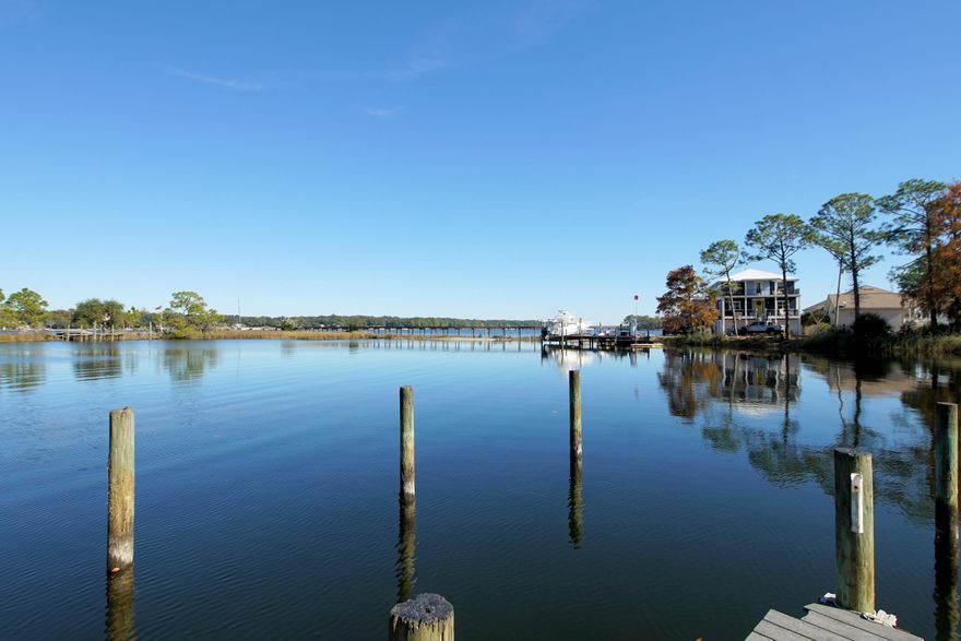 Welcome home to your waterfront town home complex nestled in the heart of Niceville convenient to everything.  This home features 3 bedrooms with 2.5 baths.  Half bath is located downstairs for guests making it convenient.  Living room and dining room are adjacent to kitchen making it easily accessible for any gathering.   Kitchen features plenty of cabinet space efficient for any meal.  Living room with stone corner fireplace ideal for those cool winter nights.  This home offers laminated flooring making cleaning a breeze.  Bring your boat for this complex offers a dock, and a boat slip or launch your kayak, paddle board or simply fish from the dock. The shared landscaped courtyard is perfect for your extended entertaining and a short walk to the dock.  Make this your first choice and