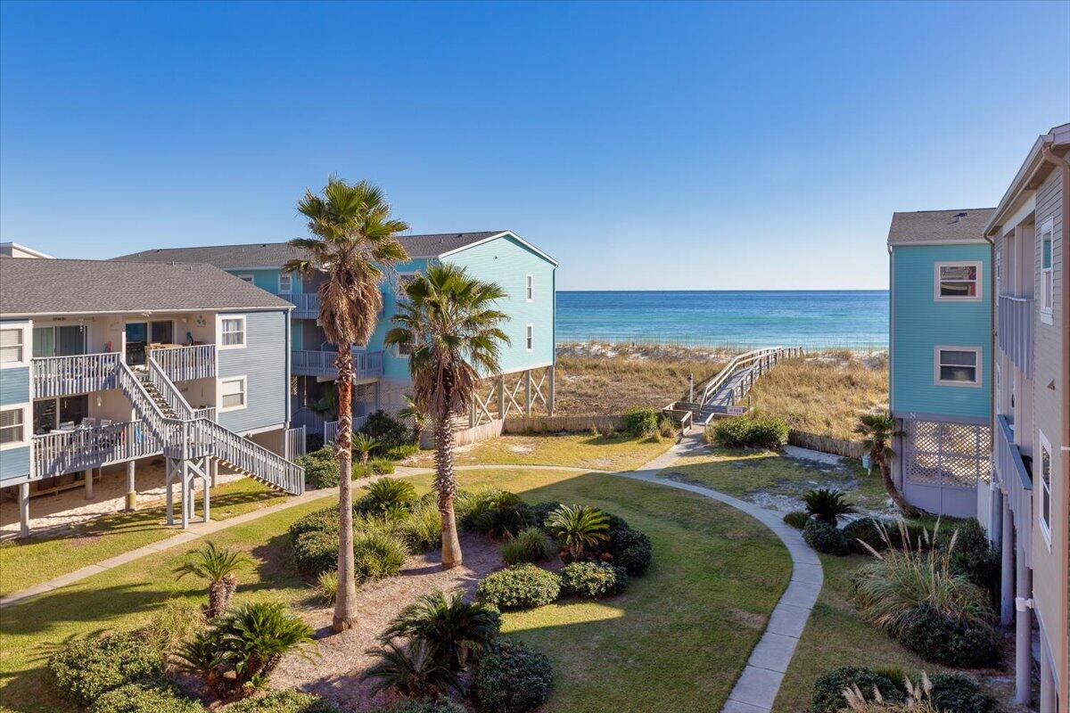 Top Floor! Stunning 1 bedroom, 1 bathroom  condo with Unobstructed Gulfview in Villas on the Gulf on Pensacola Beach.  Wow your friends, family and guests with the unbelievable view! The Gulf View and Beach access do not get any better with this beautifully remodeled large 1 bedroom 1 bath condo. This beach escape space was updated inside in 2021 and features beautiful tile flooring, gorgeous cabinets and granite countertops in the kitchen and a large walk-in shower in the bathroom. This short-term rental is turnkey and comes fully furnished! The spacious balcony as an unobstructed view of the Gulf. Once you are here you will never want to leave! The AC unit is only 4 years old. Villas on The Gulf is a quiet and relaxed Gulf side complex (no roads to cross) with immaculate grounds and community pool - The wood walkover and outdoor shower make beach days a breeze. Pensacola Beach is known for its sugar white sand, turquoise waters and amazing beach culture! Bars and restaurants are less than 5 mins away.