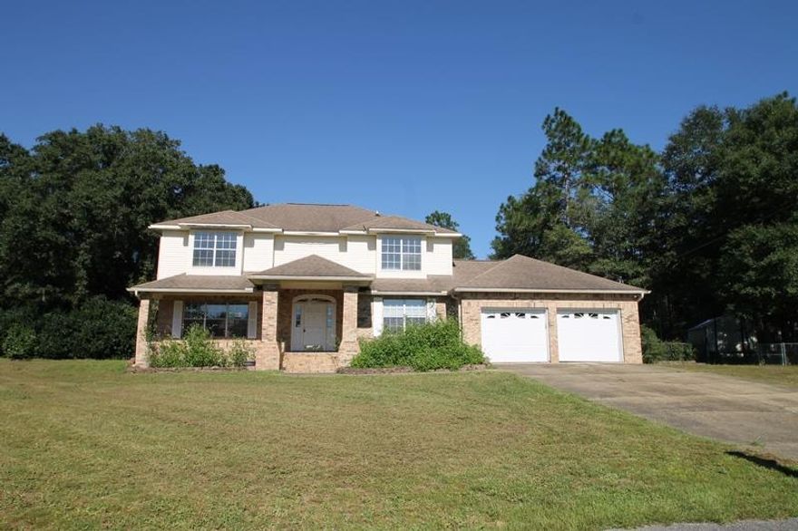 Real Estate Owned.  Property in central Crestview but is located in the COUNTY so no city taxes. Hard to find central location on a cul de sac with over an acre lot. 4 bedrooms and 3 full baths including two master suits one upstairs and one downstairs. Two Living Areas, Eat-In Kitchen and Dining Room, Fireplace, Massive Enclosed Florida Room. Home includes a 2 car garage. Along with this on over an acre of property is an oversized out building with additional parking and workshop area. There is a carport next to the outbuilding that can be used to park a boat or RV. Backyard Gazebo for evening relaxation. Bountiful citrus trees!! Call to take a look at 2431 Wildwood ct today.