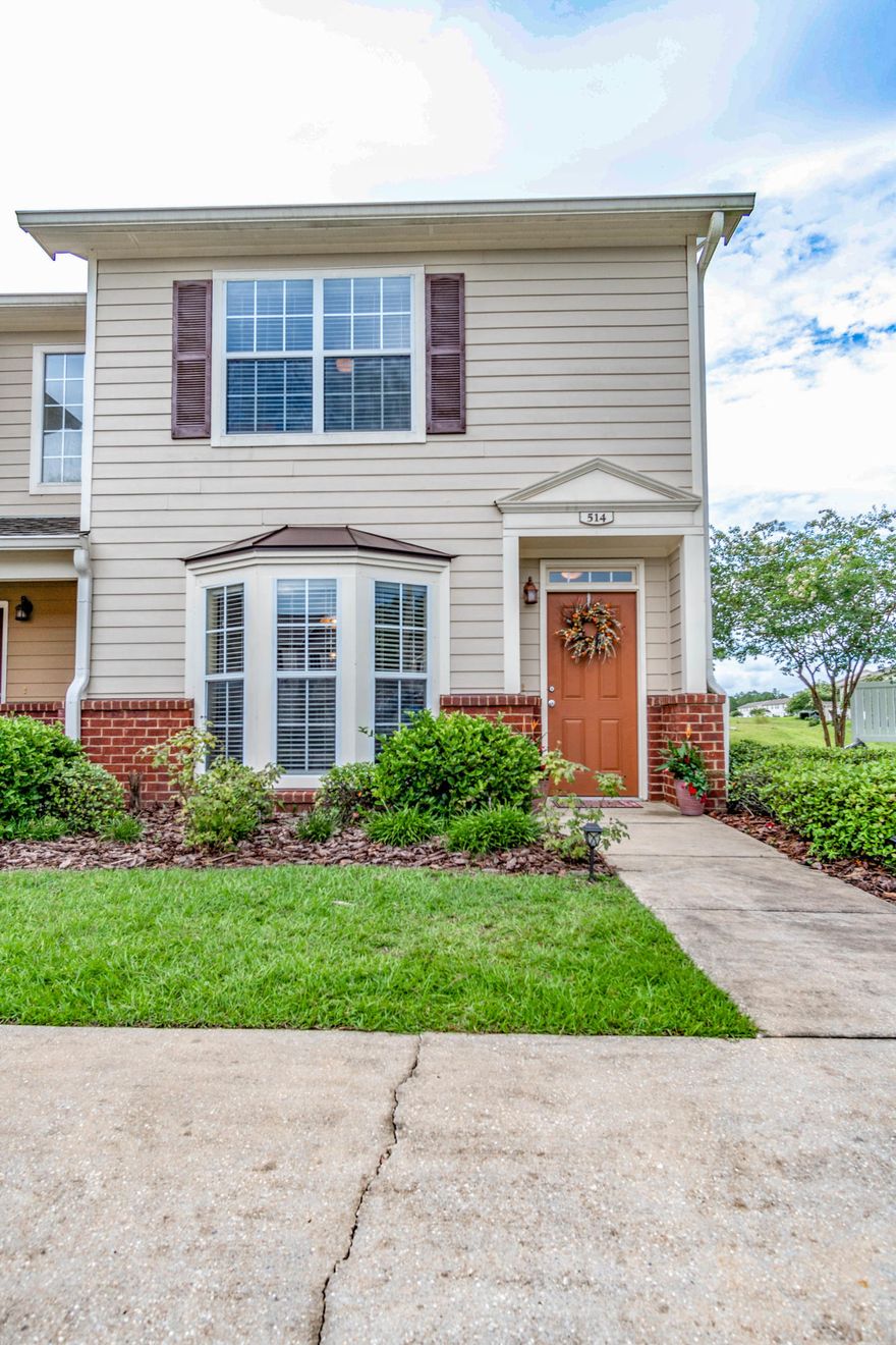 WELCOME TO EAGLES LANDING IN SOUTH CRESTVIEW!!! This SPACIOUS town home has been beautifully updated with wood flooring in the living room and dining room areas and tile in all wet areas. The home has a nice downstairs kitchen, half bathroom for company, and storage under stair well.The living room offers a beautiful bay window and white columns that few town homes offer in this community. The upstairs offer an extra wide stair case leading to two two large bedrooms that both accommodate king sized beds and en suite full bathrooms. The town home also has a patio for enjoying the outdoors and grilling overlooking a nice green space. This home features the BONUS of being an END UNIT and has its own TWO car driveway directly in front. Community pool, playground, clubhouse, boat storage area.