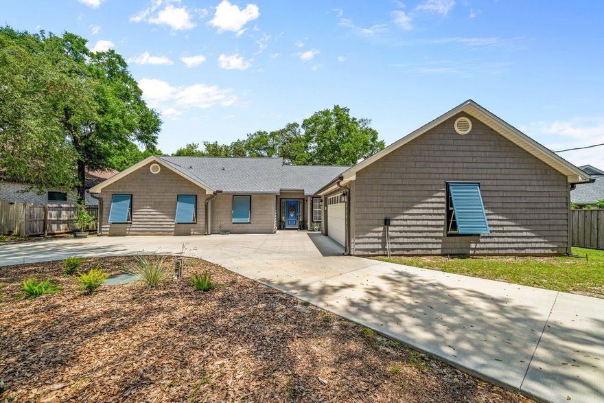 Fully renovated home located in Shalimar, FL just a block from Santa Rosa Sound beach access! Launch your paddle boards, canoes or go fishing! This 1853 sq foot home has 4 bedrooms and 2 baths and has been updated throughout! This home features a new roof (2023), HVAC system (2024), and gas, tankless hot water system (2024). Enter the lovely foyer and notice an open floor plan with the kitchen opening to the living room and kitchen areas. The kitchen features new custom cabinetry and crown. There is custom cabinet hardware and soft close drawers! The kitchen also features a custom tiled backsplash, new gold faucet and new recessed lighting. The appliances were updated to include a side by side refrigerator with icemaker with water, a slide in electric stove/oven, rangehood, microwave, and dishwasher. All appliances are stainless and black. The cabinets are modern shaker style with white uppers and beautiful blue lower cabinets. There is a peninsula or breakfast bar that seats up to 4 or 5 guests! The exquisite quartz counter tops and custom wood columns and ceiling beam finishes off this gorgeous kitchen design! The kitchen opens to an eat in kitchen area that could also be a home office! There is additional custom lighting with pendant lighting over the peninsula and a custom chandelier over the eat in kitchen area! The dining room is large enough for a 10 to 12 person dining room table! This area also has large picturesque windows overlooking the fenced back yard and open deck! The living room features vaulted ceilings, recessed lighting, a new custom ceiling fan, and a gas fireplace (2025) with a mantel and white vertical shiplap wall covering! The entire home has wide plank luxury vinyl plank flooring. The primary bedroom is very large and features recessed lighting, a custom ceiling fan and an updated ensuite bathroom. The primary bathroom has a new custom tiled walk in shower, new double vanity with quartz counter tops and under mount sink, a separate water closet and a large walk in closet! The primary shower features a niche, shower bench with a quartz seat and new shower faucets! No detail was missed in this home with over $10,000 spent on custom closet systems, new hardware on doors and cabinets, mirrors, new vanity lighting and faucets in the updated bathrooms. There are three additional guest bedrooms and a fully updated guest bathroom! Finally, the interior of the home features a laundry room with a sink basin! The interior has been professionally painted with new base molding, and lighting throughout. The exterior was also updated to include all new exterior custom Colonial Grey shaker vinyl siding, new concrete circular driveway, Military Blue Bahama shutters for the front windows, a Sentricon Preventative System that is monitored, and new connection to public sewer. The homeowner also had the Ducts cleaned by NADCA certified contractor Advantaclean. There is gas available for grilling on the open deck, exterior new gutters with a leaf guard, and a oversized two car garage. The shed is adorable and perfect as a he or she shed. There are two public beaches within a few blocks of this home! Buyer to verify all dimensions and information! 